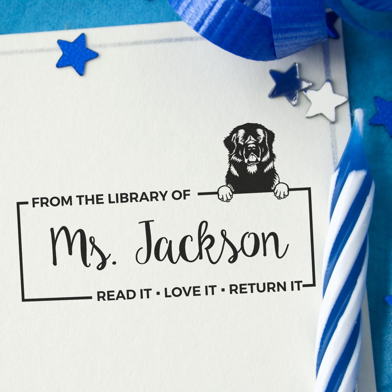 Personalized rubber stamp for books, reading From the Library of Ms. Jackson with dog design and star accents.