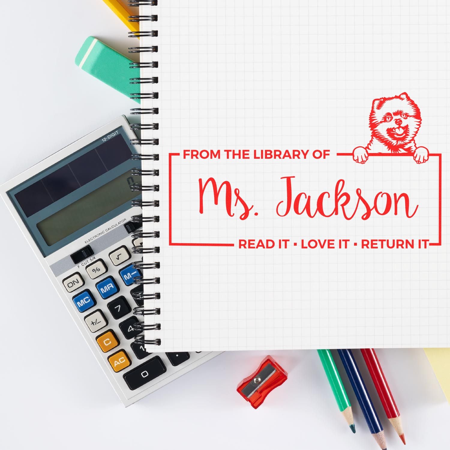 Custom library ownership rubber stamp reading From the Library of Ms. Jackson, Read It, Love It, Return It on notebook.