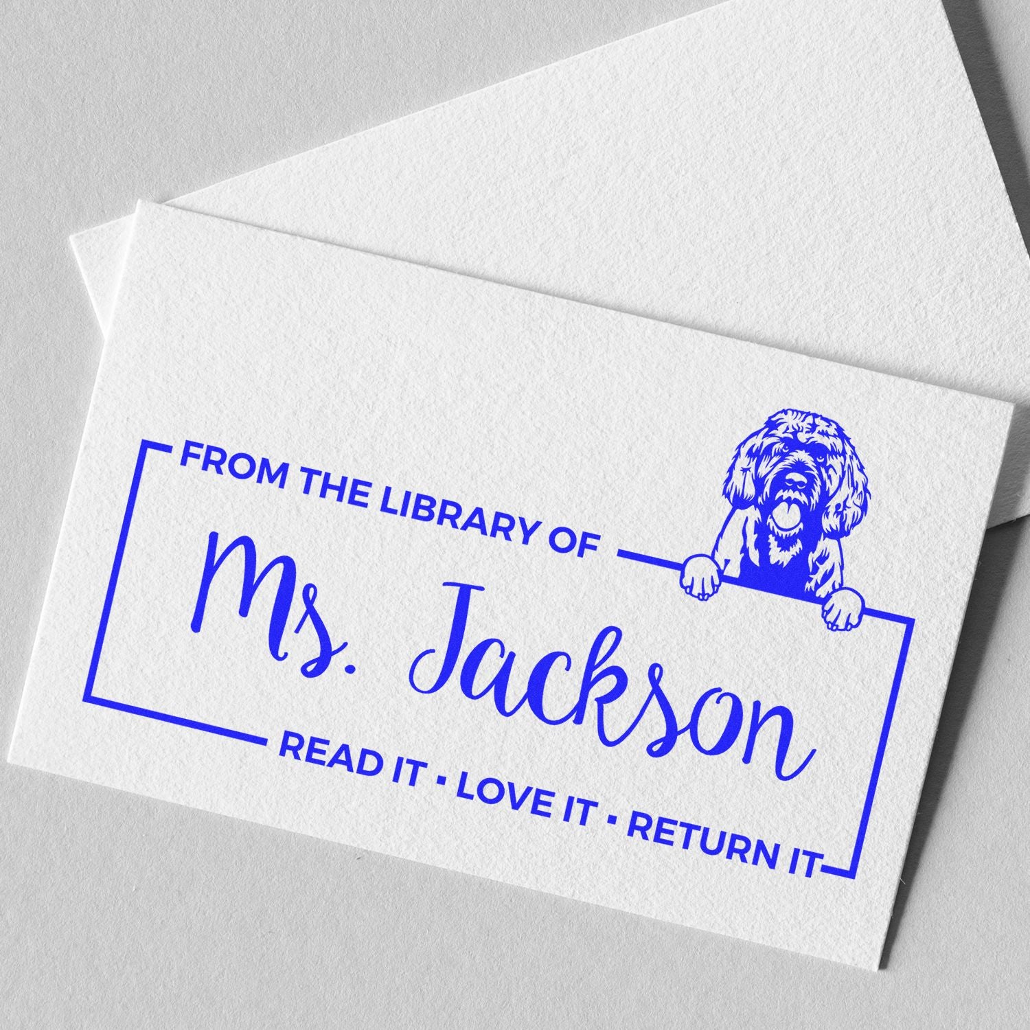 Personalized library return stamp for Mrs. Jackson with dog illustration and Read it, love it, return it text.