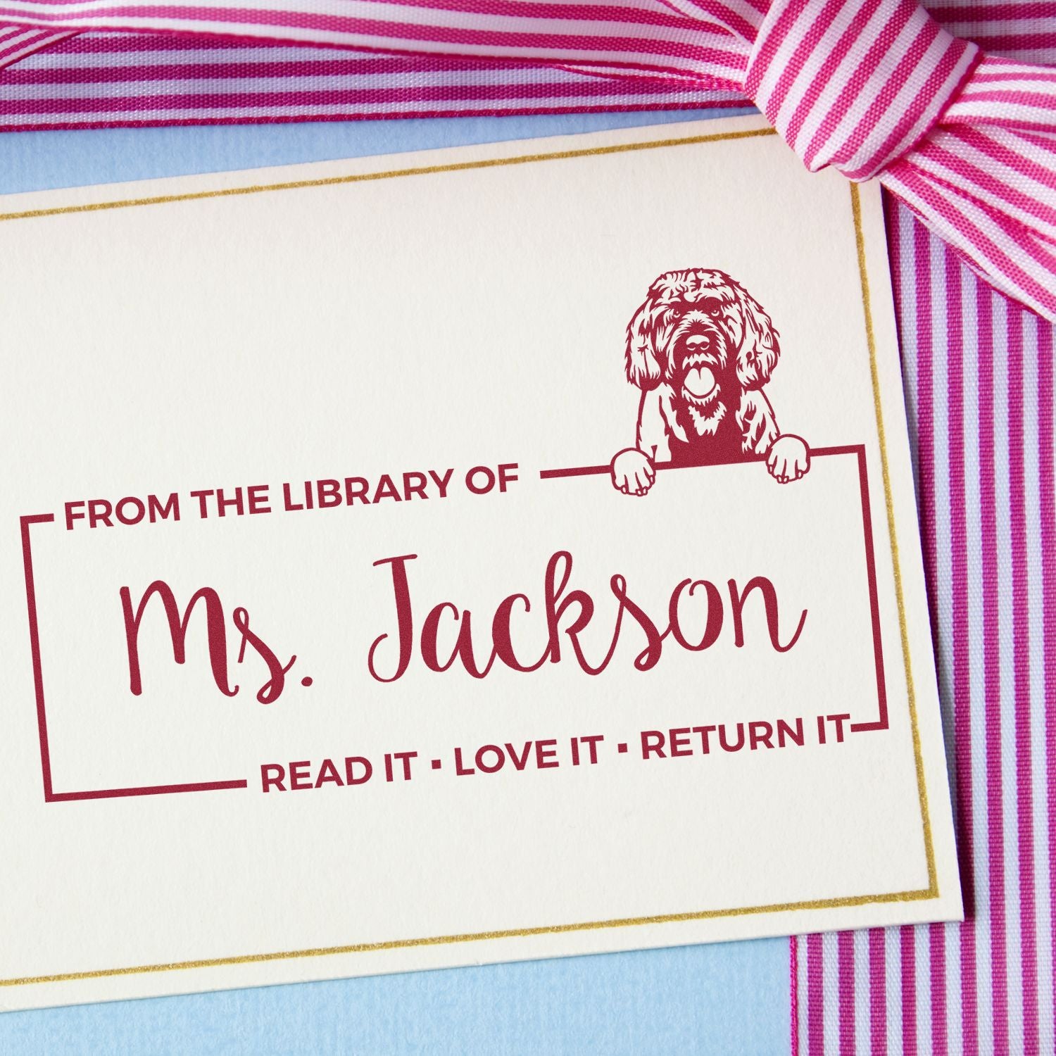 Personalized library return rubber stamp for Ms. Jackson, featuring dog artwork and Read It  Love It  Return It message.