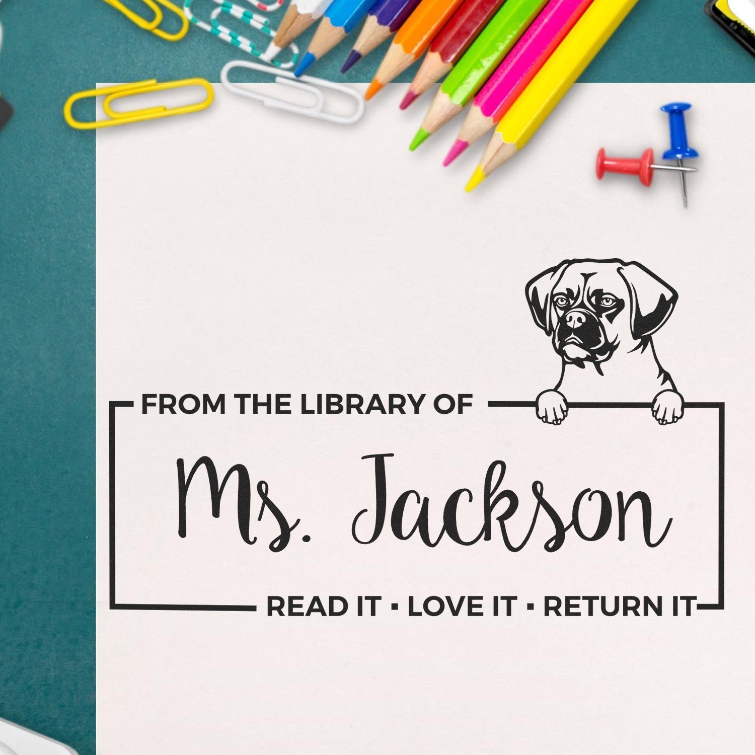 Personalized library rubber stamp with dog design and Ms. Jackson name, perfect for marking books and classroom materials.