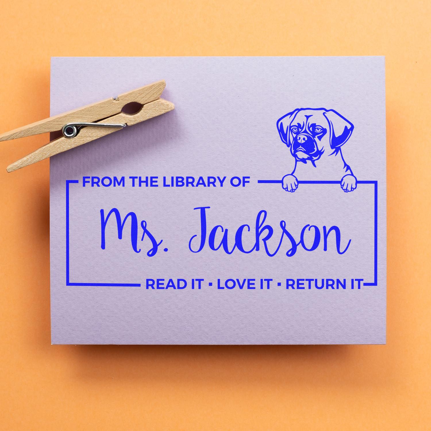 Custom rubber library book stamp with dog illustration and From the Library of Ms. Jackson return label.