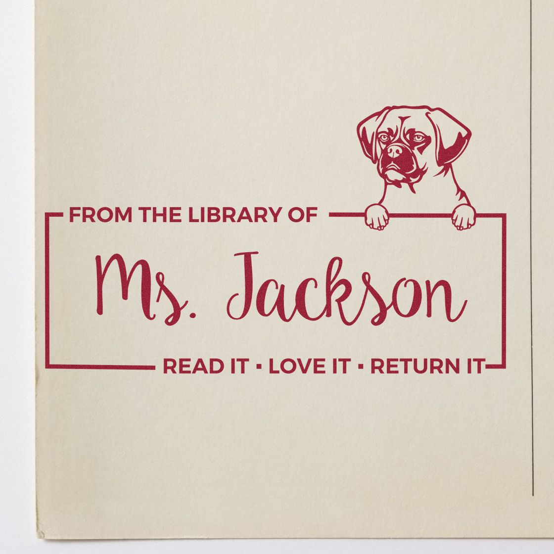 Custom rubber stamp with dog illustration and From the Library of Ms. Jackson book return message for personal books.