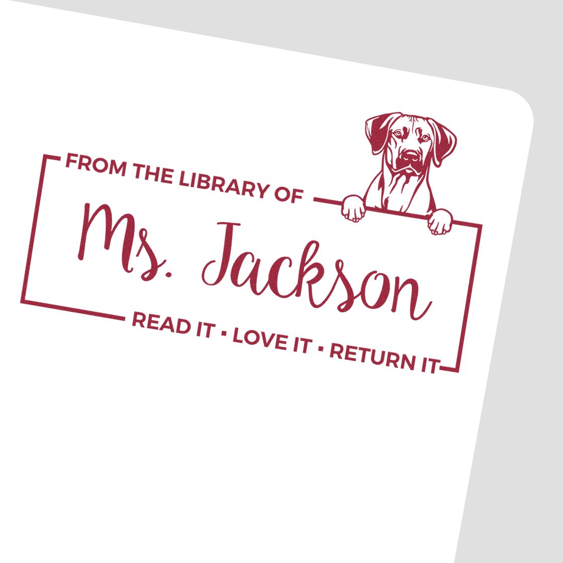 Custom rubber library stamp with dog illustration and From the Library of Ms. Jackson read it, love it, return it.
