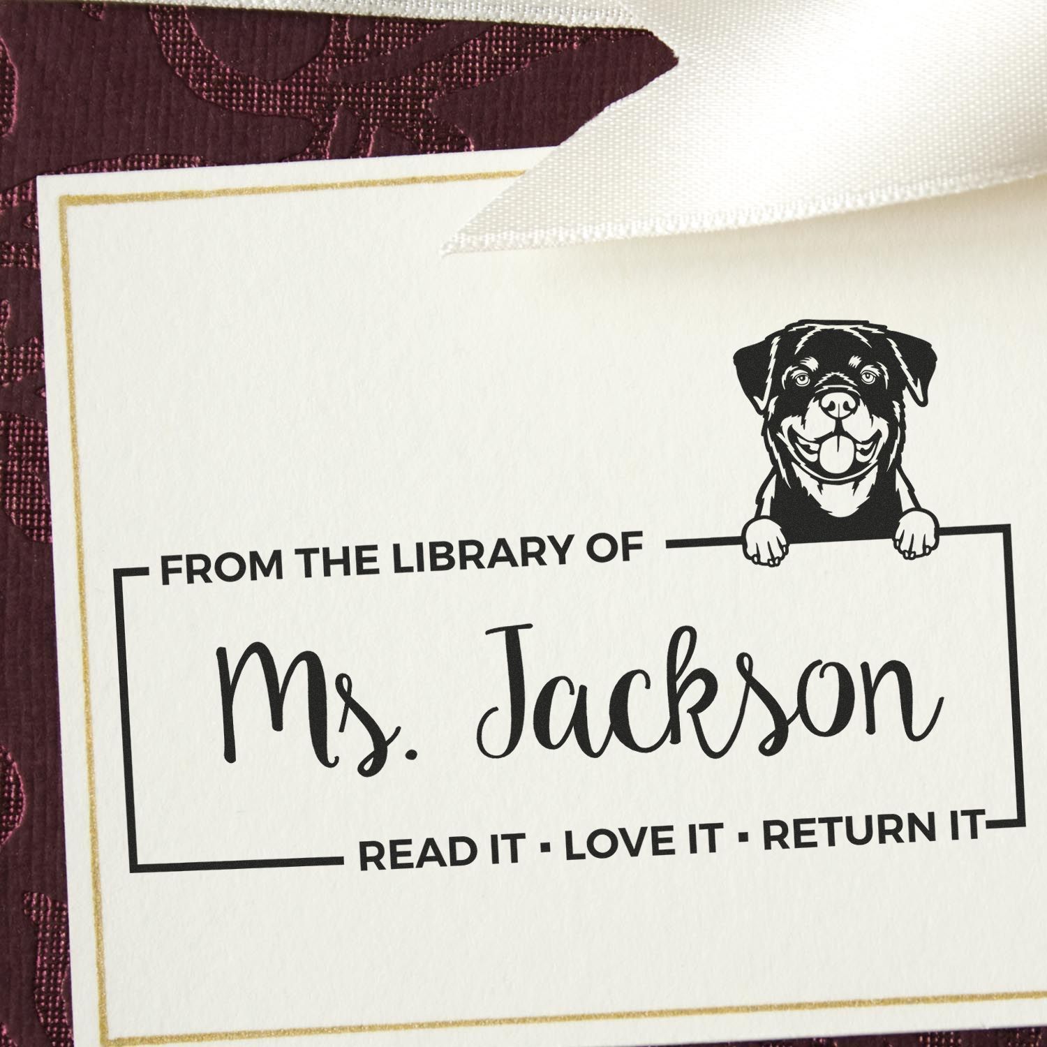 Personalized custom rubber library stamp for Ms. Jackson, featuring a dog design and book return reminder for borrowed books.
