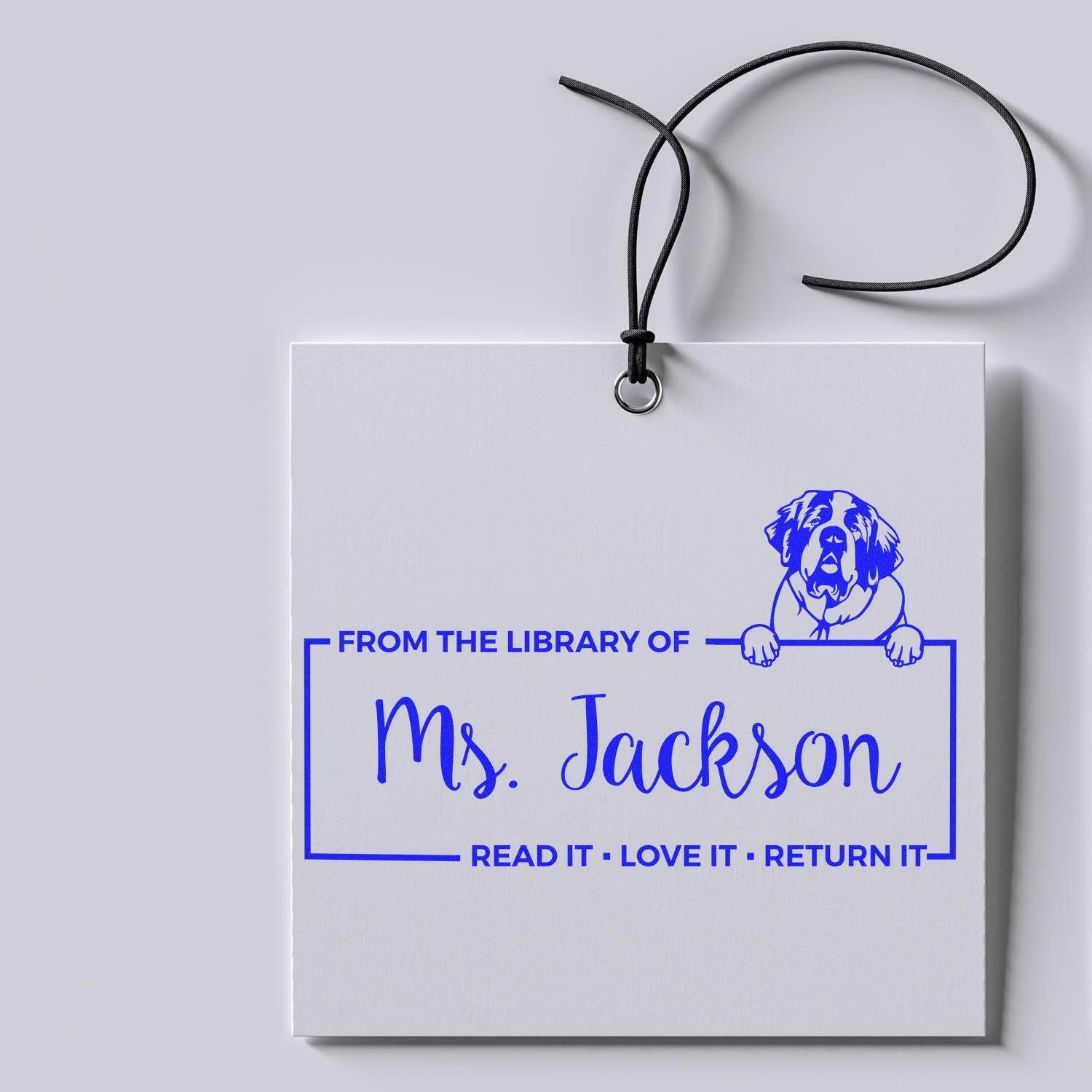 Personalized library rubber stamp with dog illustration and From the Library of Ms. Jackson book return message.