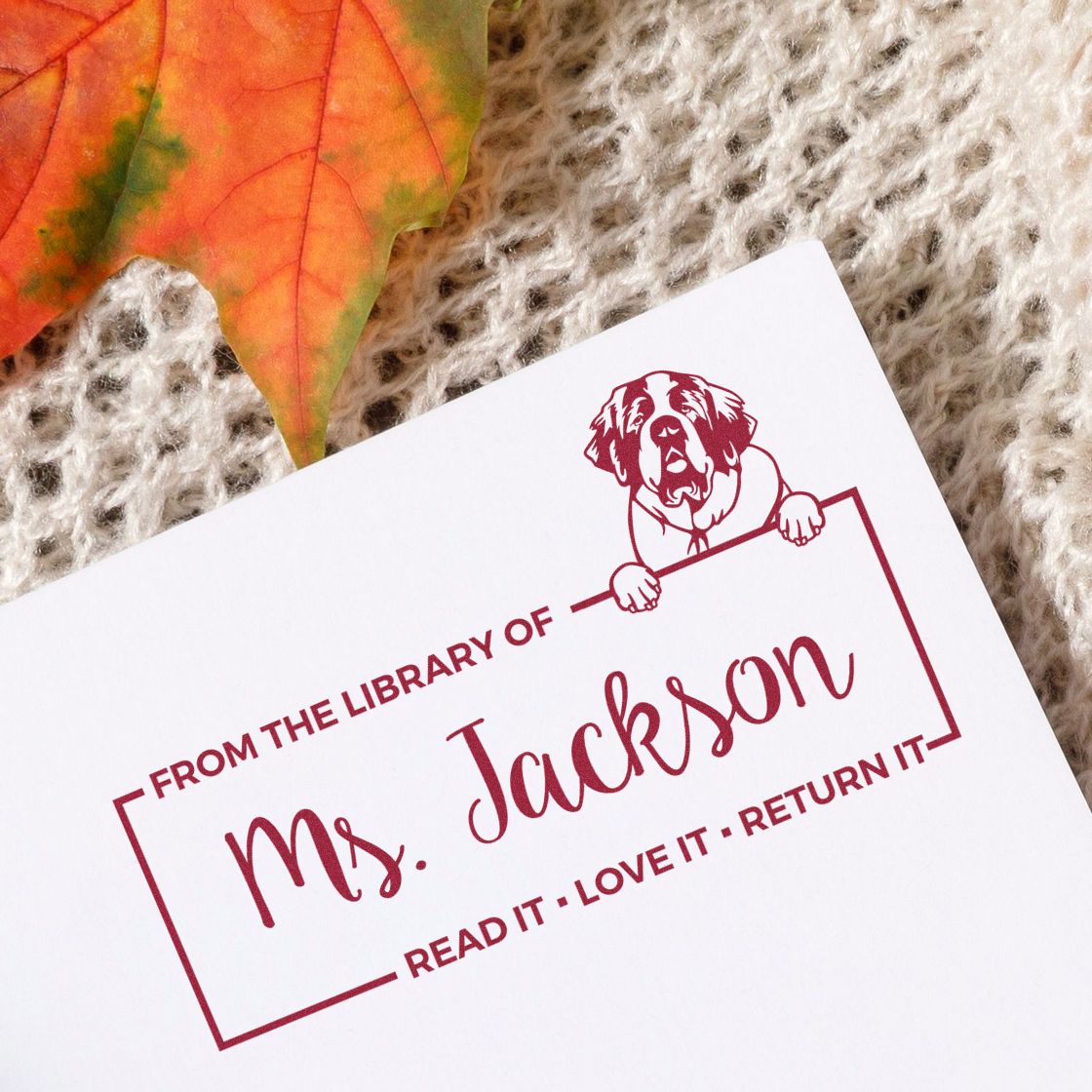 Personalized library rubber stamp for Ms. Jackson with dog design and Read it, love it, return it book ownership text.