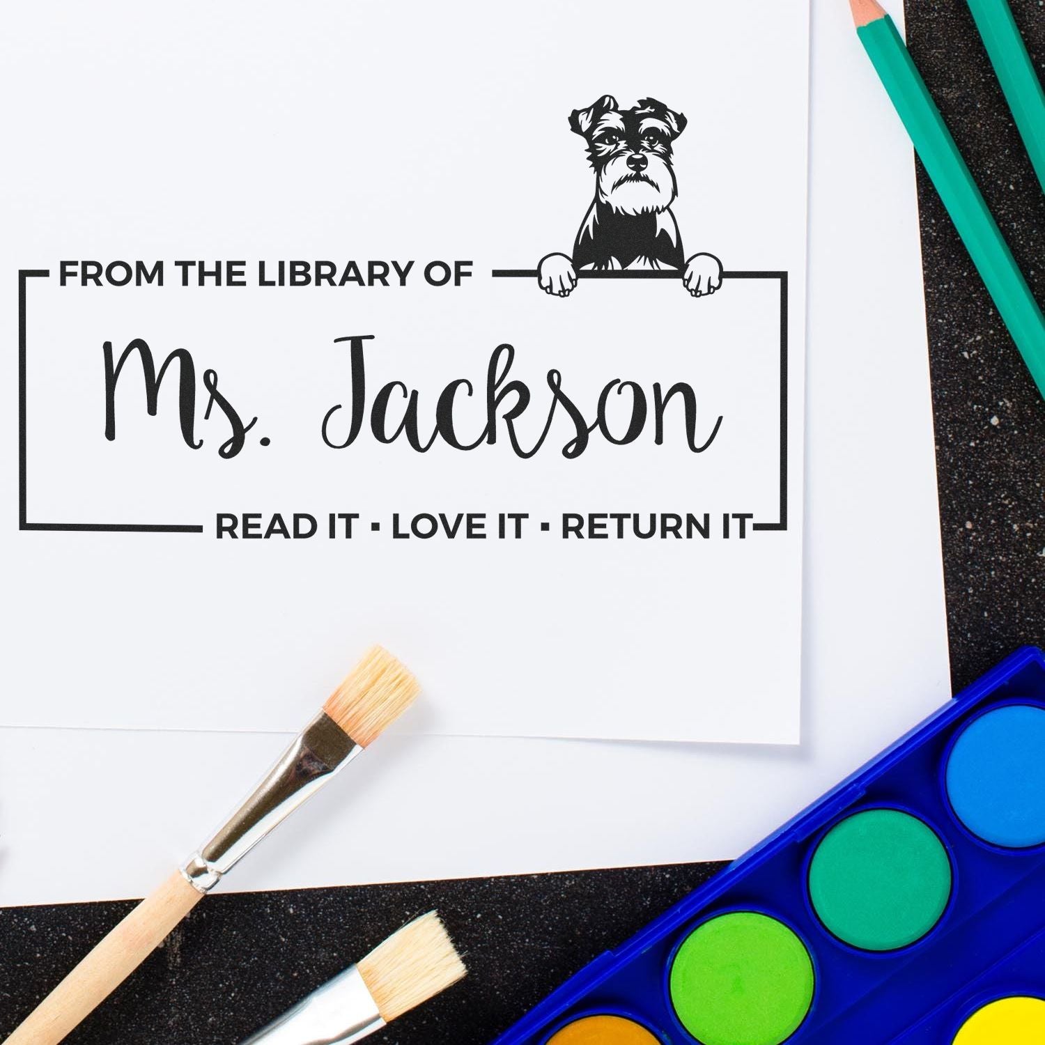 Personalized library rubber stamp for Ms. Jackson with dog illustration and Read It, Love It, Return It book return message.