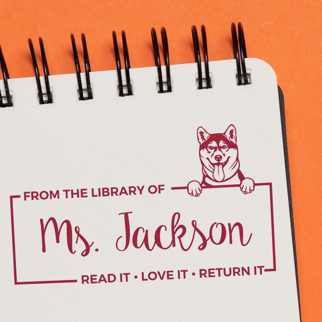 Custom rubber stamp for Ms. Jacksons library books with dog illustration and Read it, Love it, Return it message.