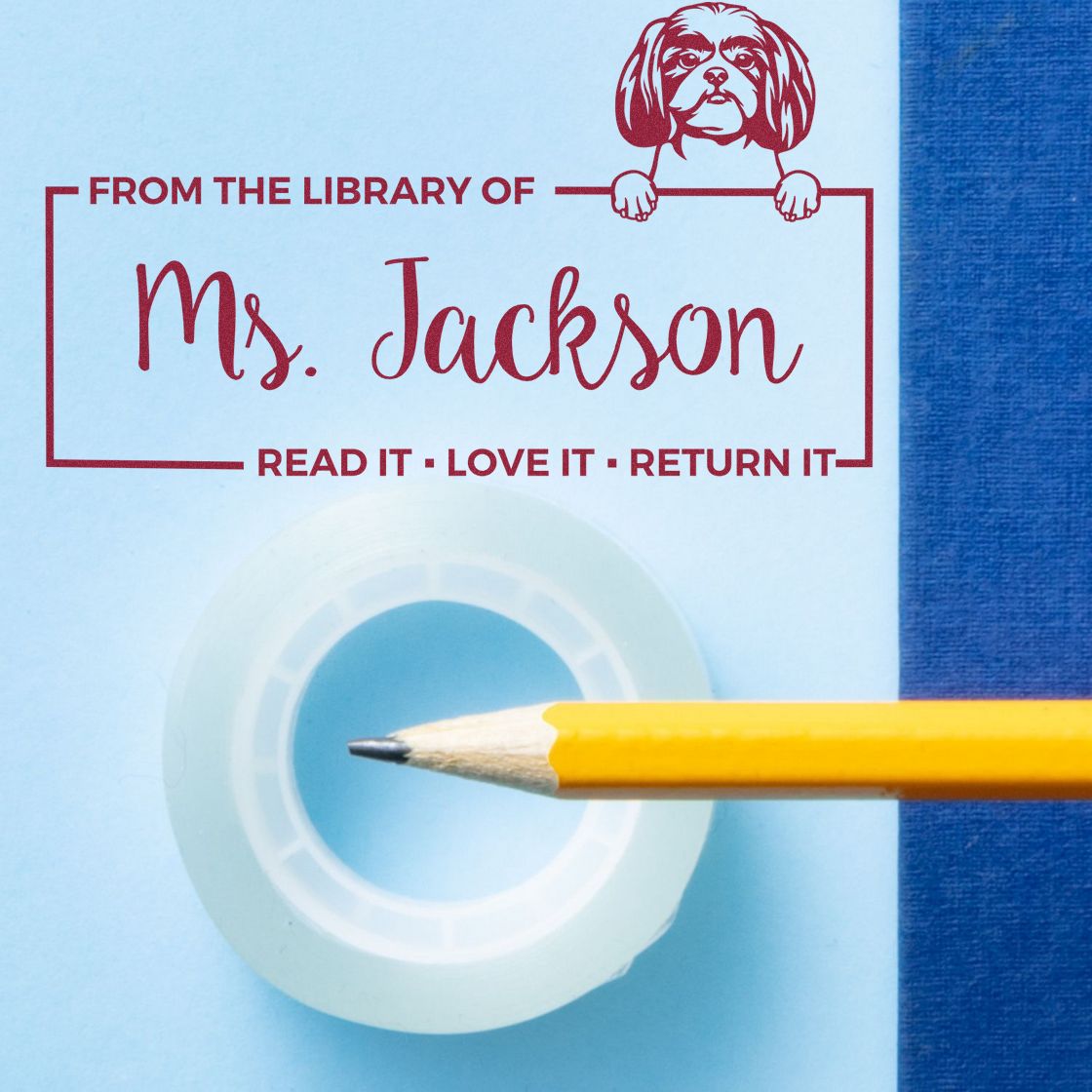 Personalized library rubber stamp for Ms. Jackson, featuring dog art and Read It, Love It, Return It bookplate text