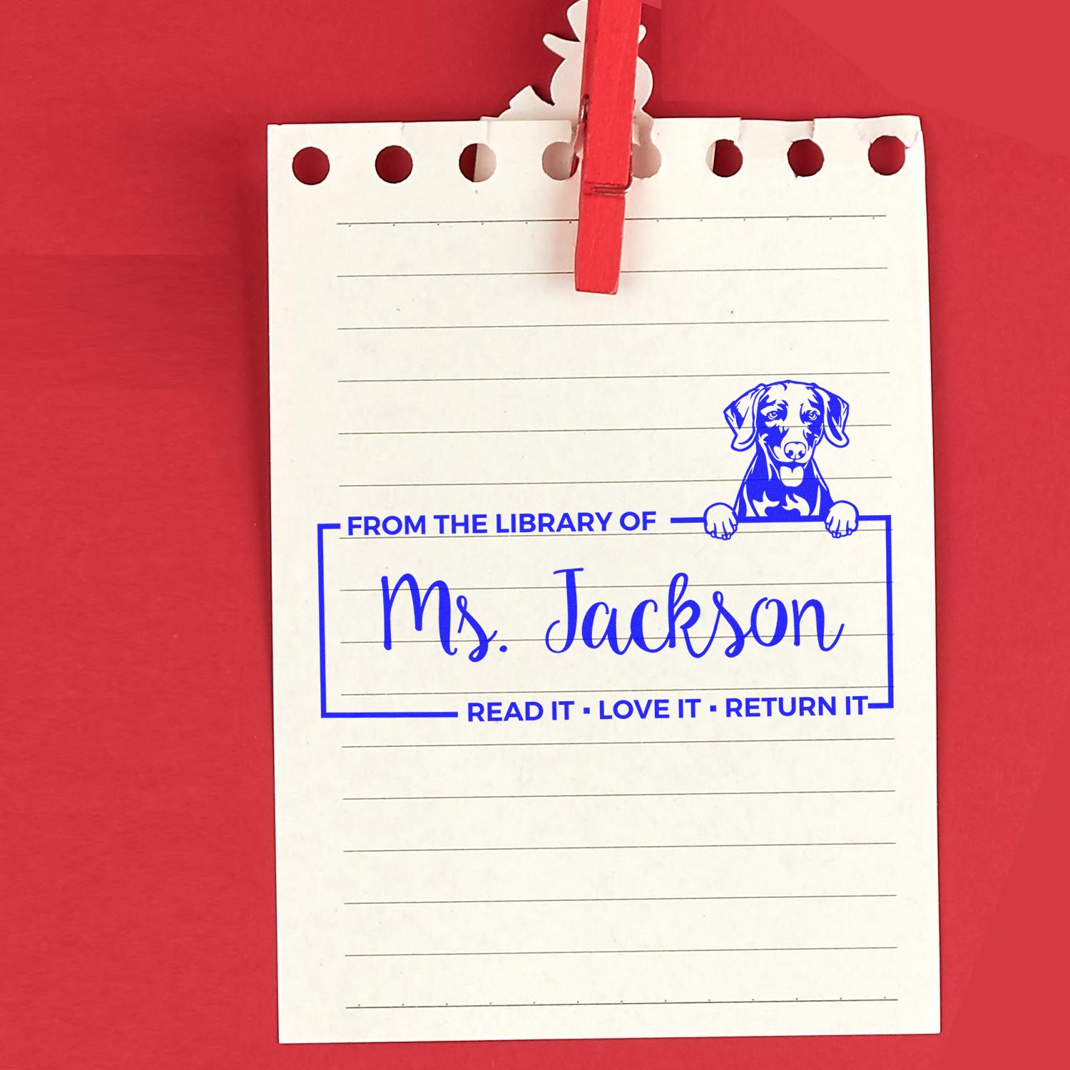 Custom library rubber stamp on lined notepad, personalized for Ms. Jackson with dog icon and Read it, love it, return it message.