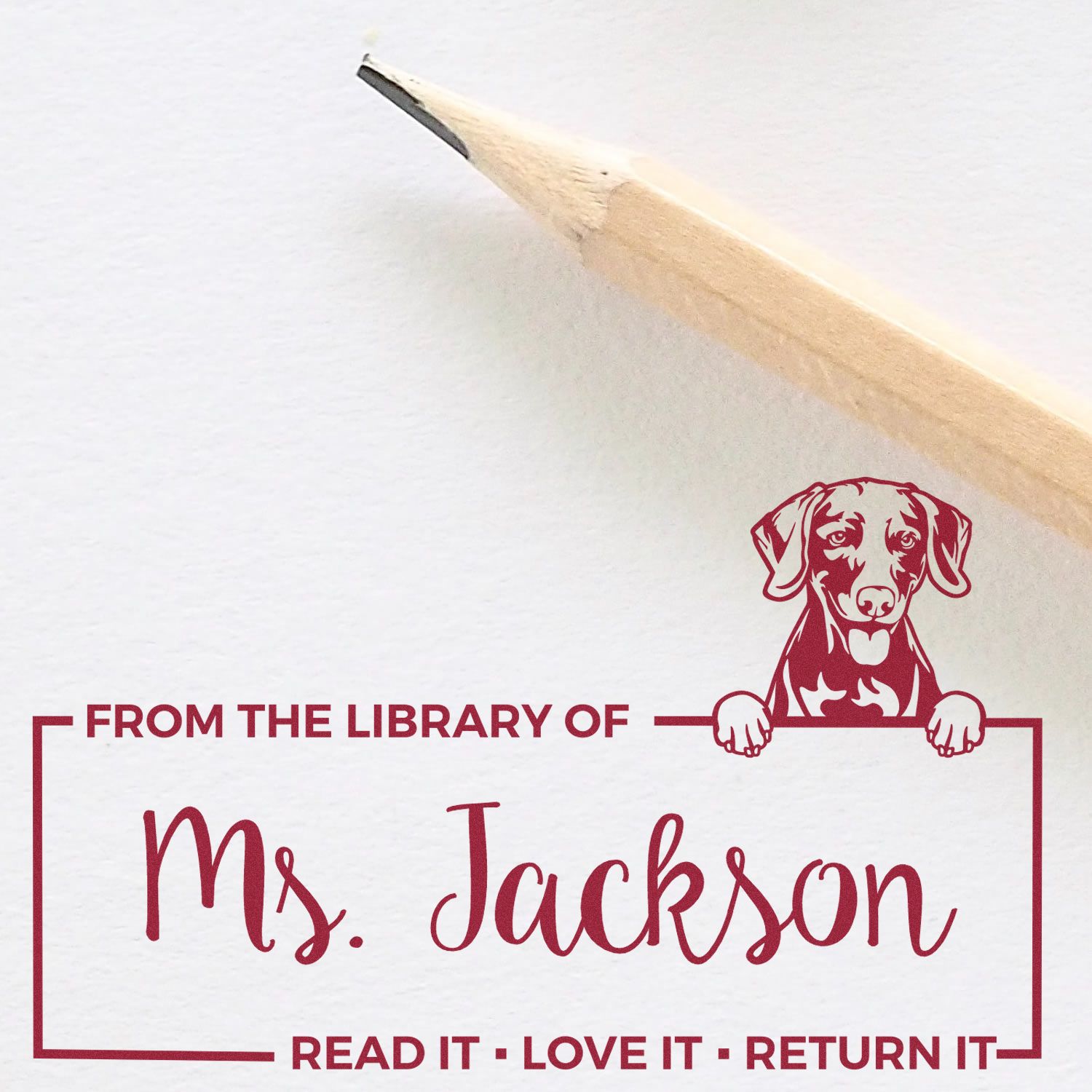Personalized custom library rubber stamp for Ms. Jackson with dog illustration and return-it book label.