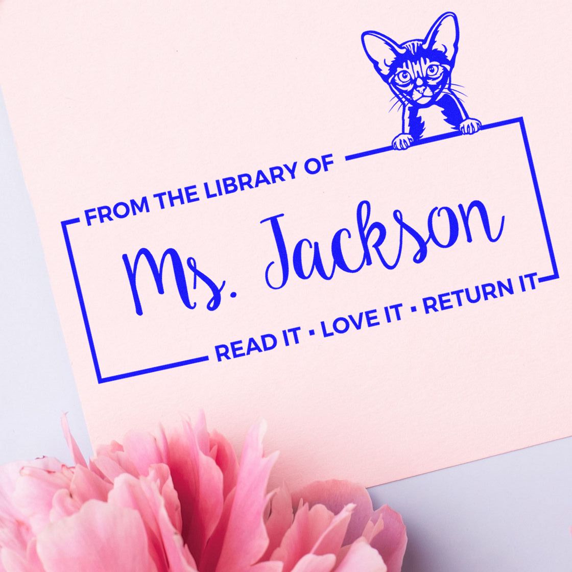 Personalized cat library rubber stamp for Ms. Jackson with Read it, love it, return it book ownership message.