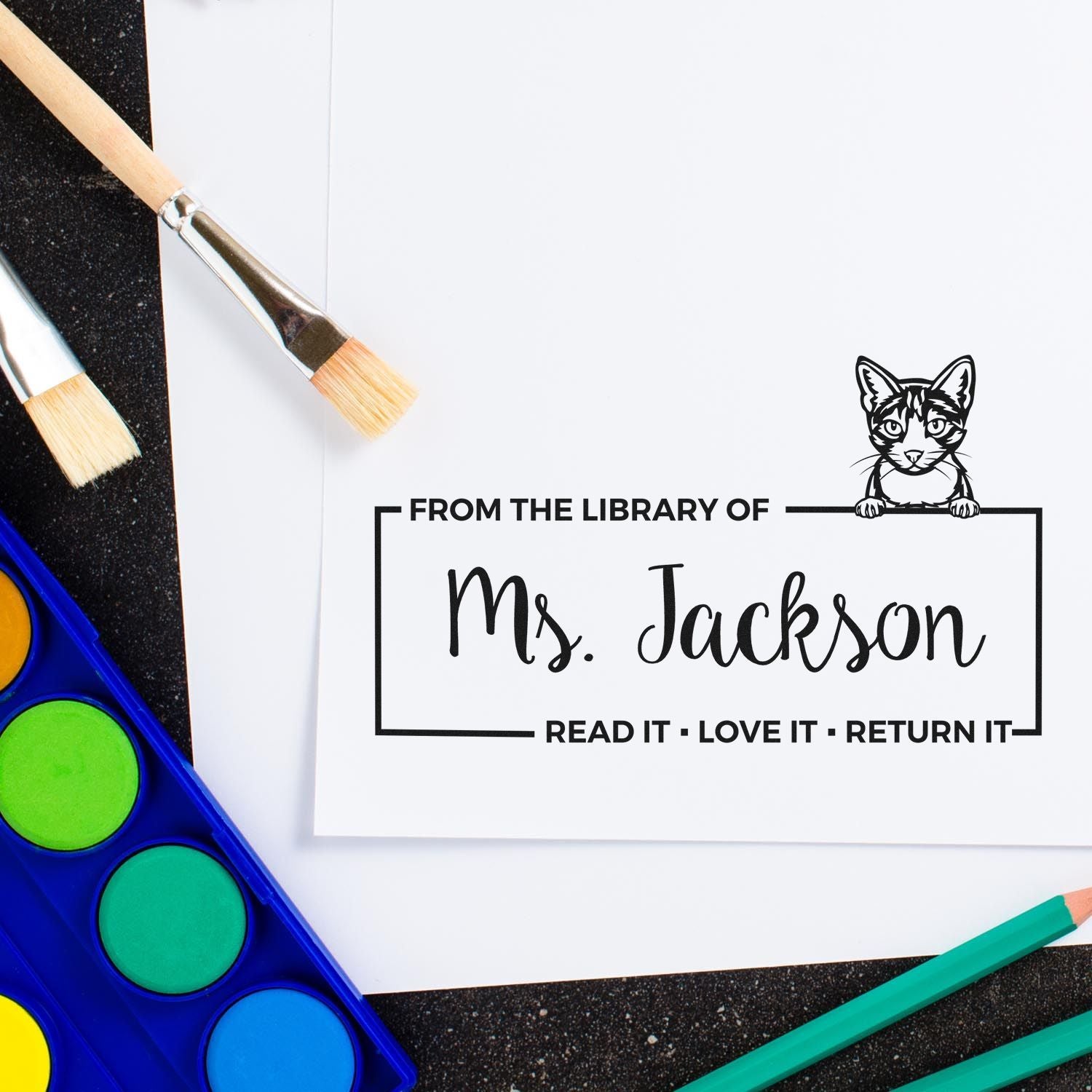 Custom library book rubber stamp for Ms. Jackson with cat design and Read it, Love it, Return it message.