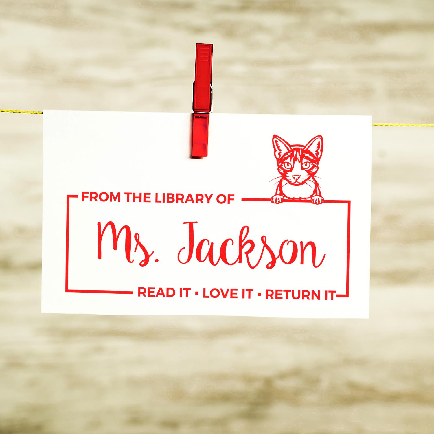 Custom library rubber stamp with cat design and Ms. Jackson name, reading Read It, Love It, Return It.