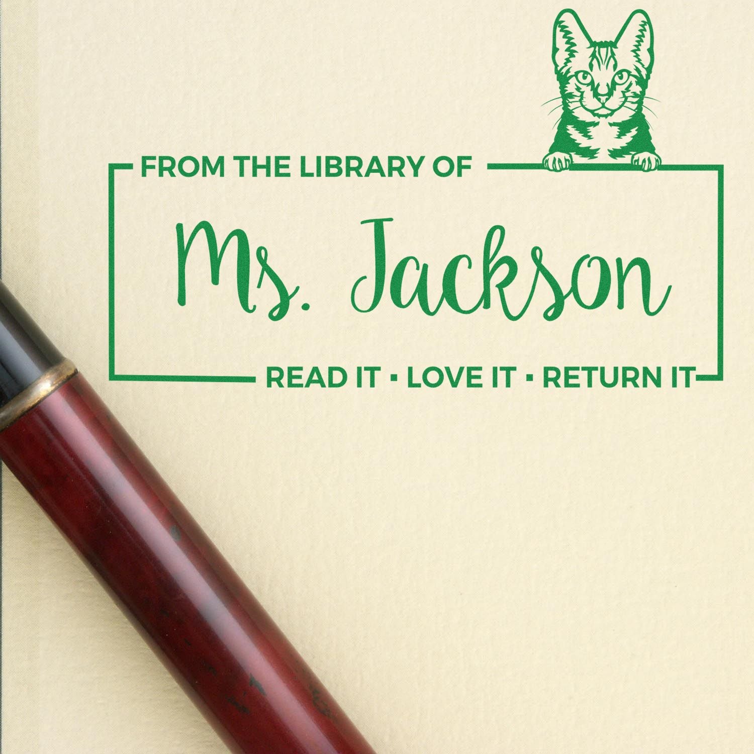 Custom bookplate rubber stamp for Ms. Jackson with cat design and Read it, love it, return it library ownership text.