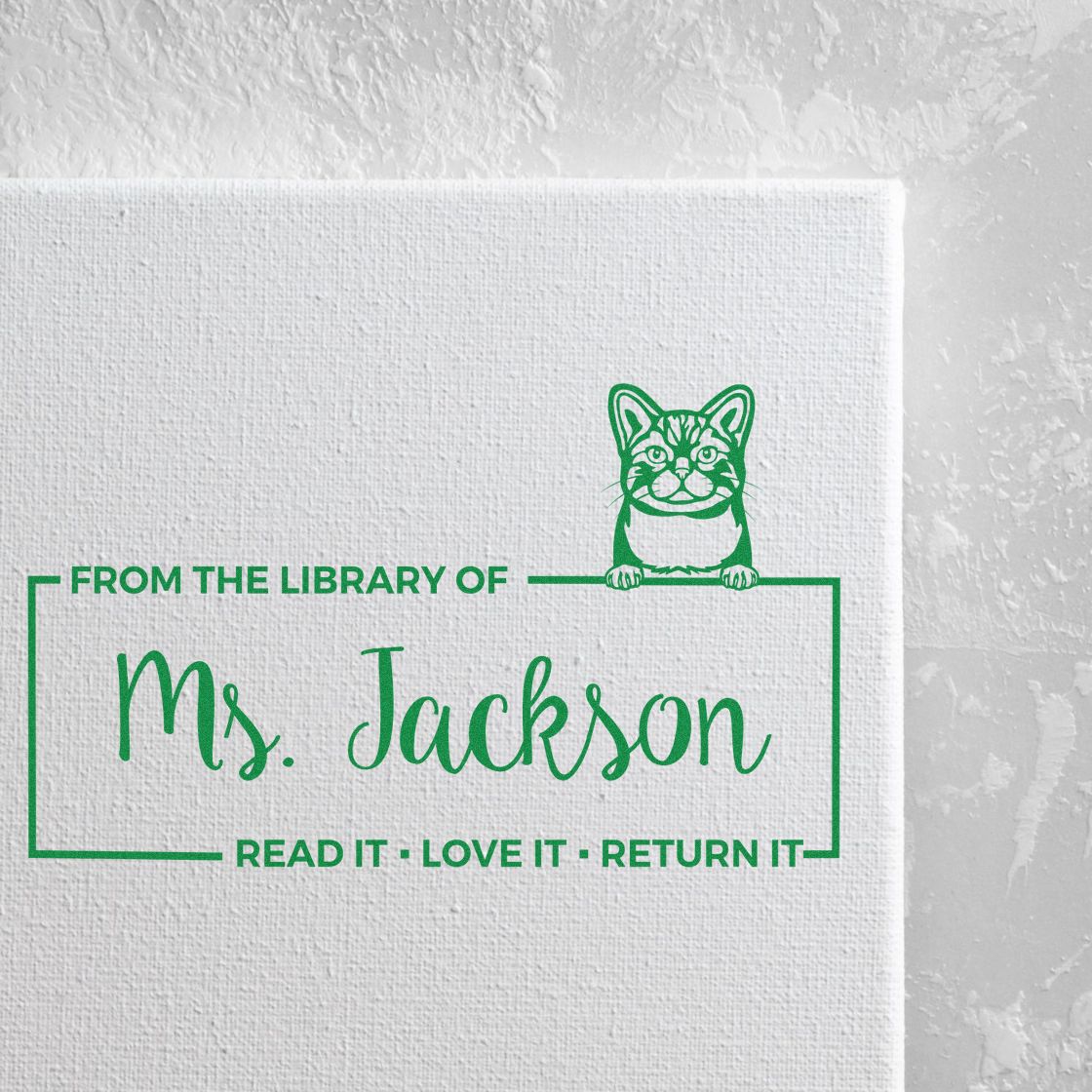 Custom library rubber stamp with cat design and From the Library of Ms. Jackson read it, love it, return it message.