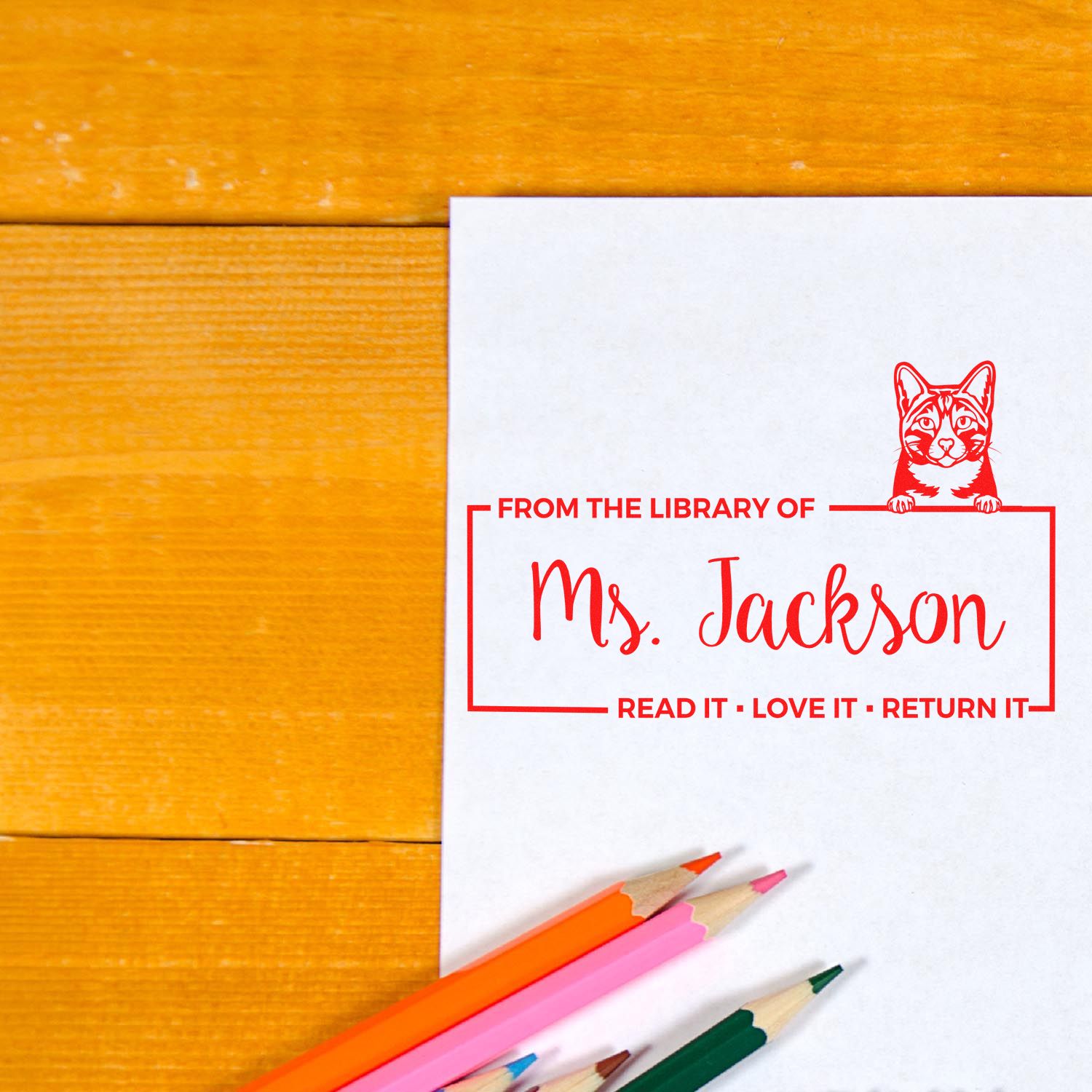 Personalized library rubber stamp for Mrs. Jackson with cat design and Read it, love it, return it bookplate.