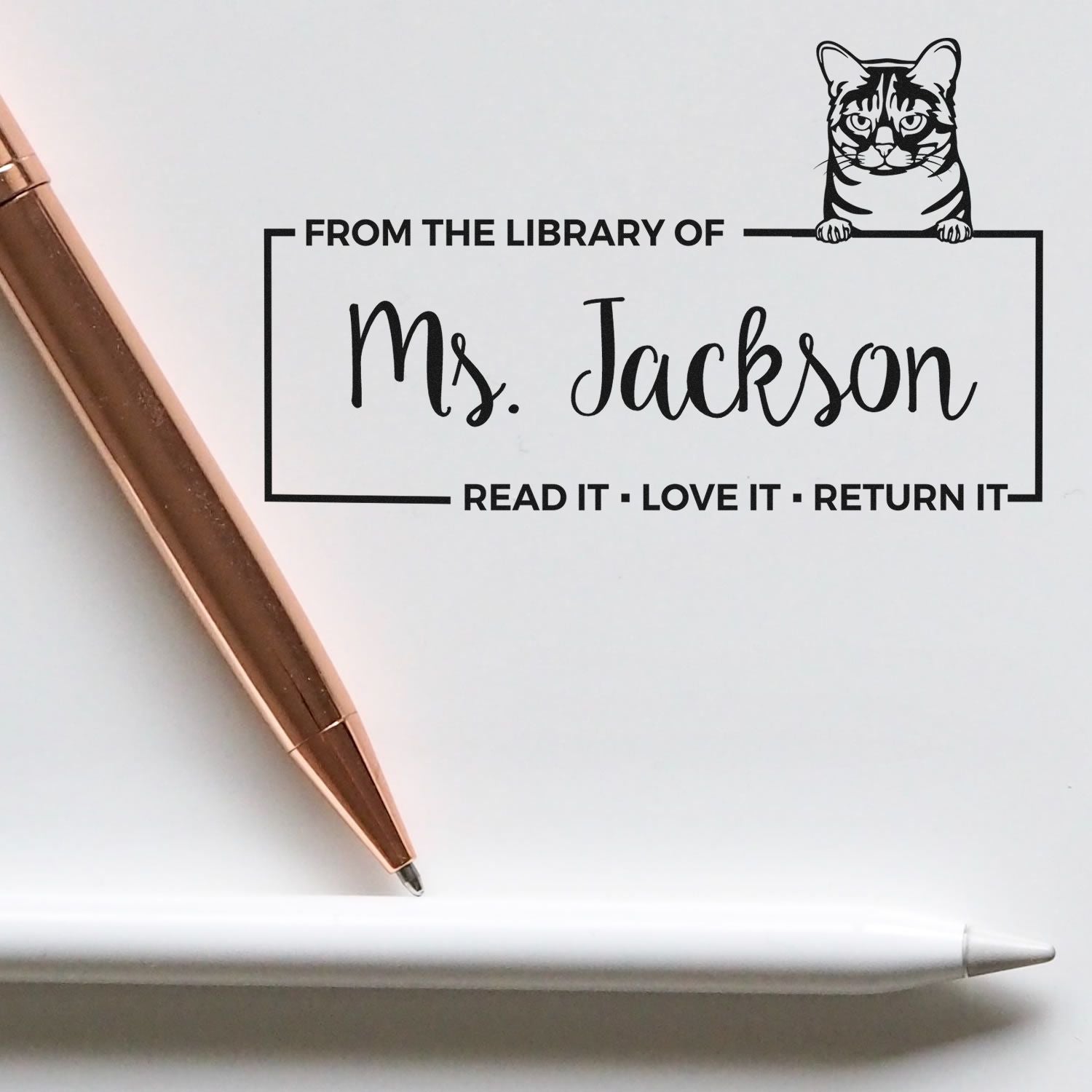 Personalized cat library book stamp for Ms. Jackson with Read It, Love It, Return It custom rubber stamp design.