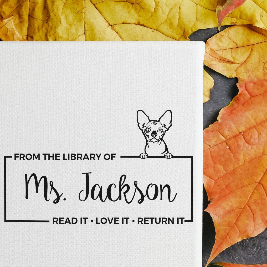 Personalized rubber library stamp with dog design and From the library of Ms. Jackson text for custom book labeling.