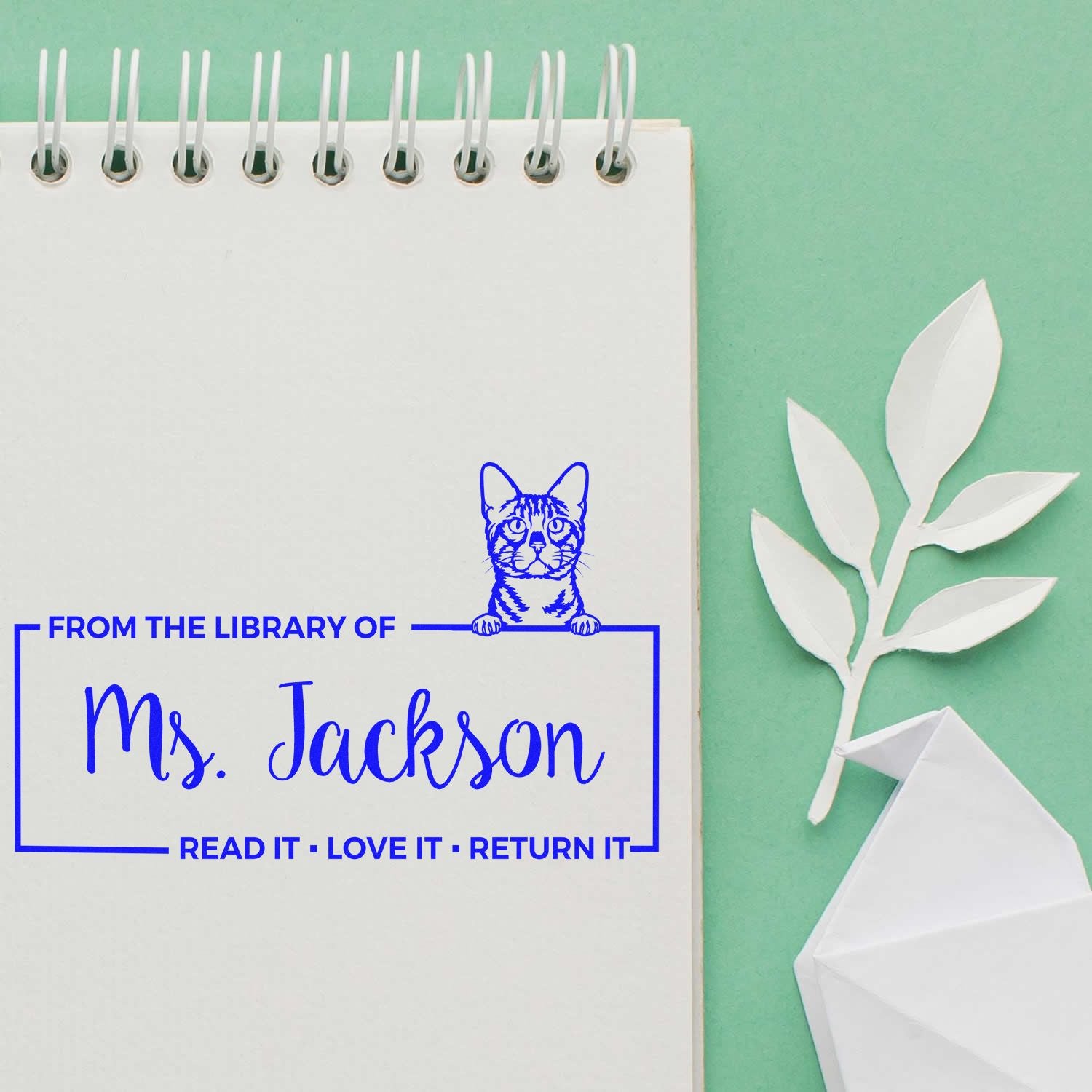 Personalized library book stamp for Ms. Jackson with cat icon and Read it, love it, return it message.