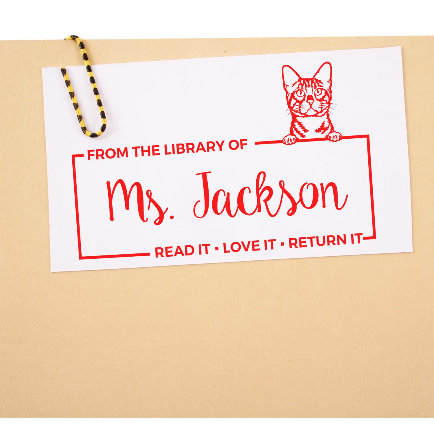 Custom library rubber stamp for Ms. Jackson with cat bookplate design and Read it, love it, return it text.