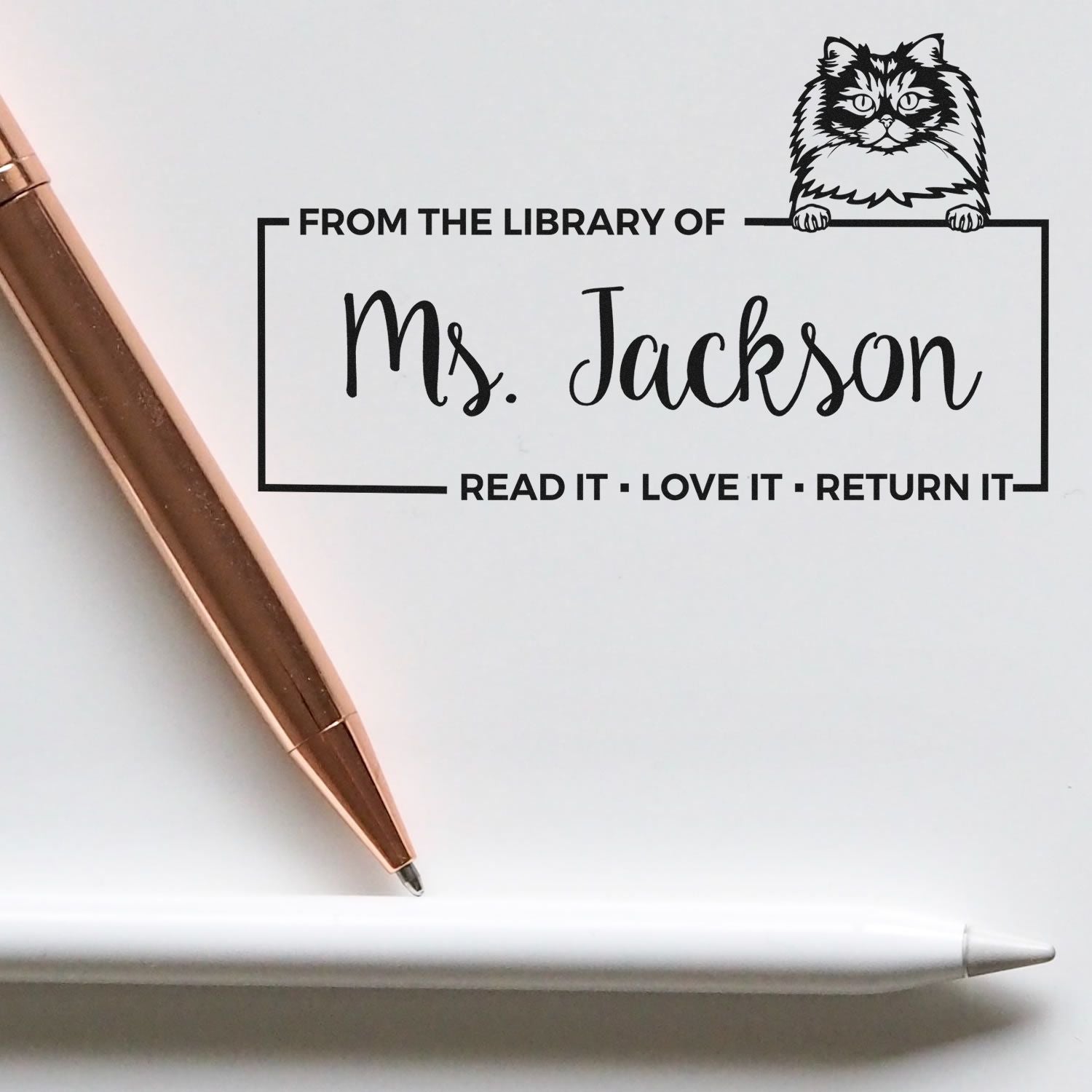 Custom library rubber stamp with cat design, reading From the library of Ms. Jackson, read it, love it, return it for book labeling.