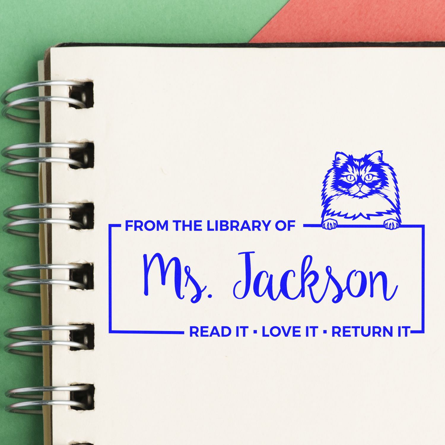 Custom library rubber stamp for Ms. Jackson with cat artwork and Read it, love it, return it book ownership message.