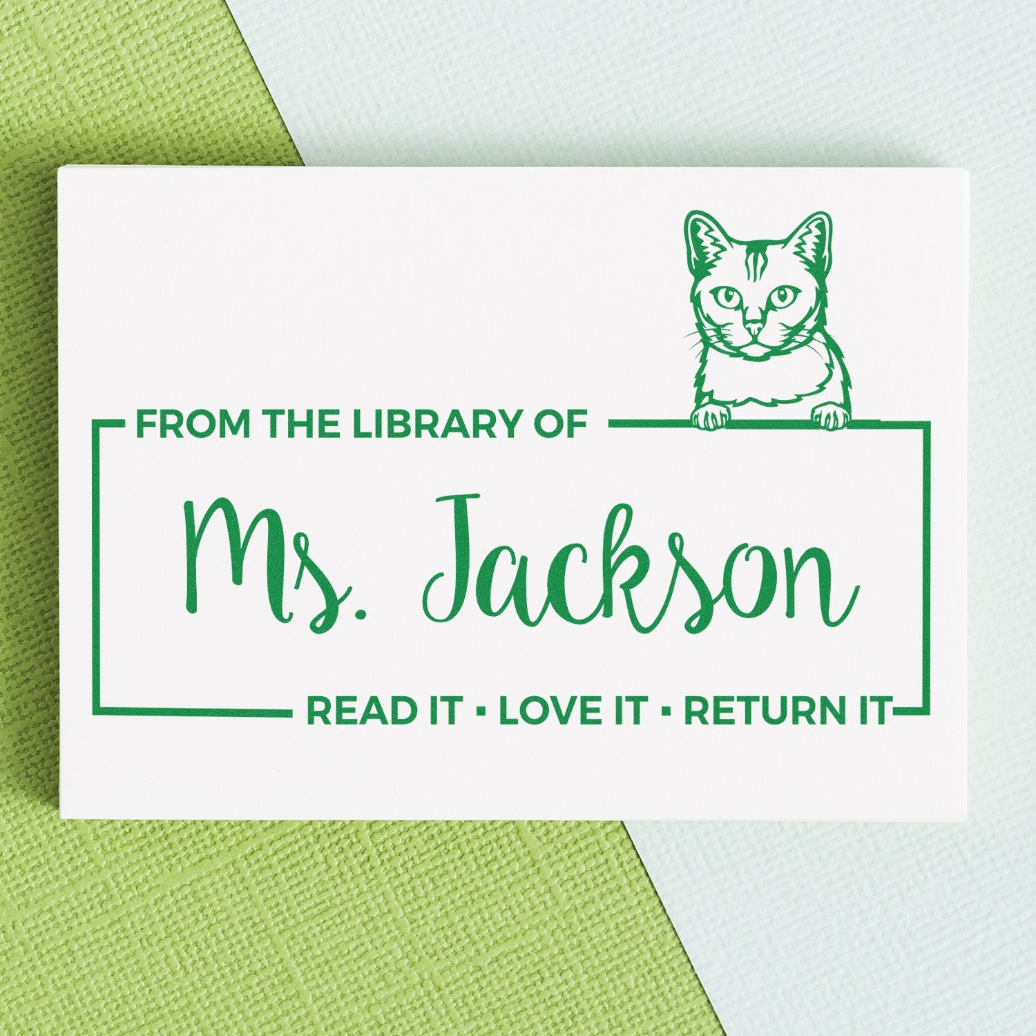 Personalized cat library rubber stamp for Ms. Jackson with From the library of and Read it, love it, return it.