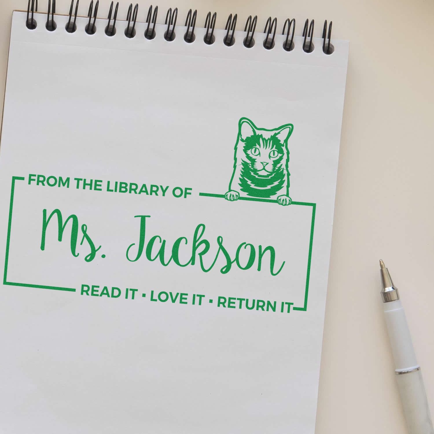 Custom library rubber stamp with cat design and bookplate text: From the Library of Mrs. JacksonRead it, Love it, Return it.
