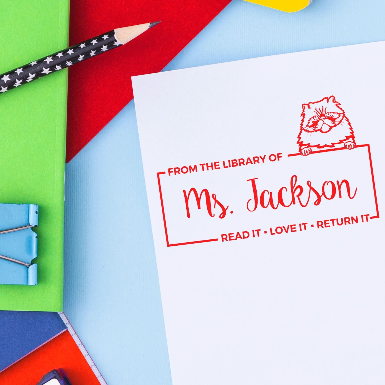 Custom library rubber stamp for Mrs. Jackson with cat design and Read it, love it, return it on a bookplate.