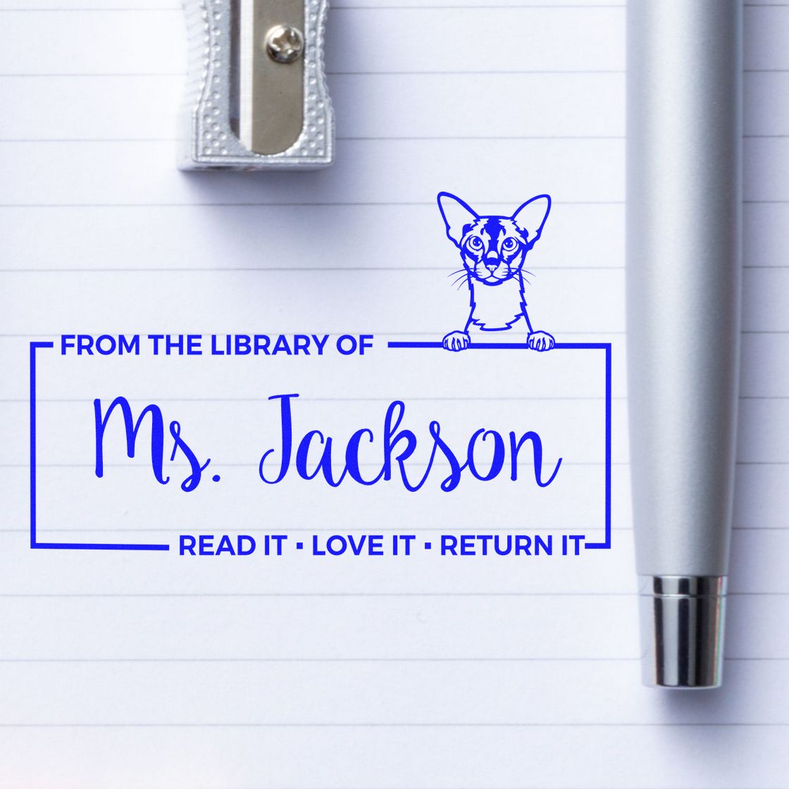 Personalized library book return rubber stamp for Ms. Jackson with cat design and Read it, love it, return it text.