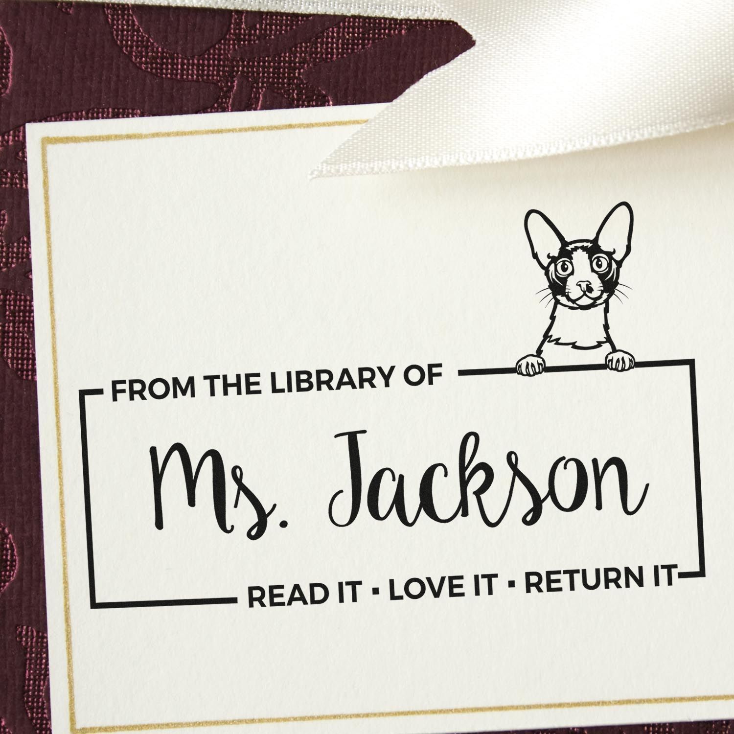 Personalized library rubber stamp for Ms. Jackson with dog illustration and From the Library of book return message.