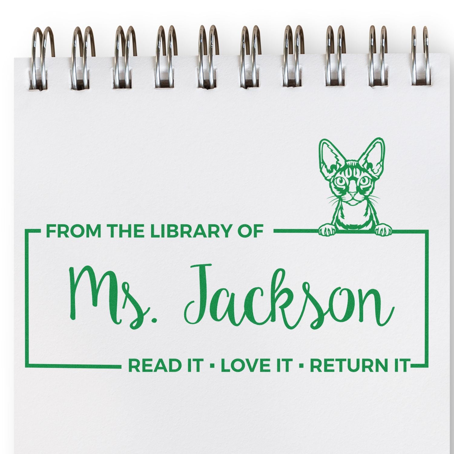 Custom library rubber stamp reading From the Library of Ms. Jackson  Read It, Love It, Return It with cat graphic.