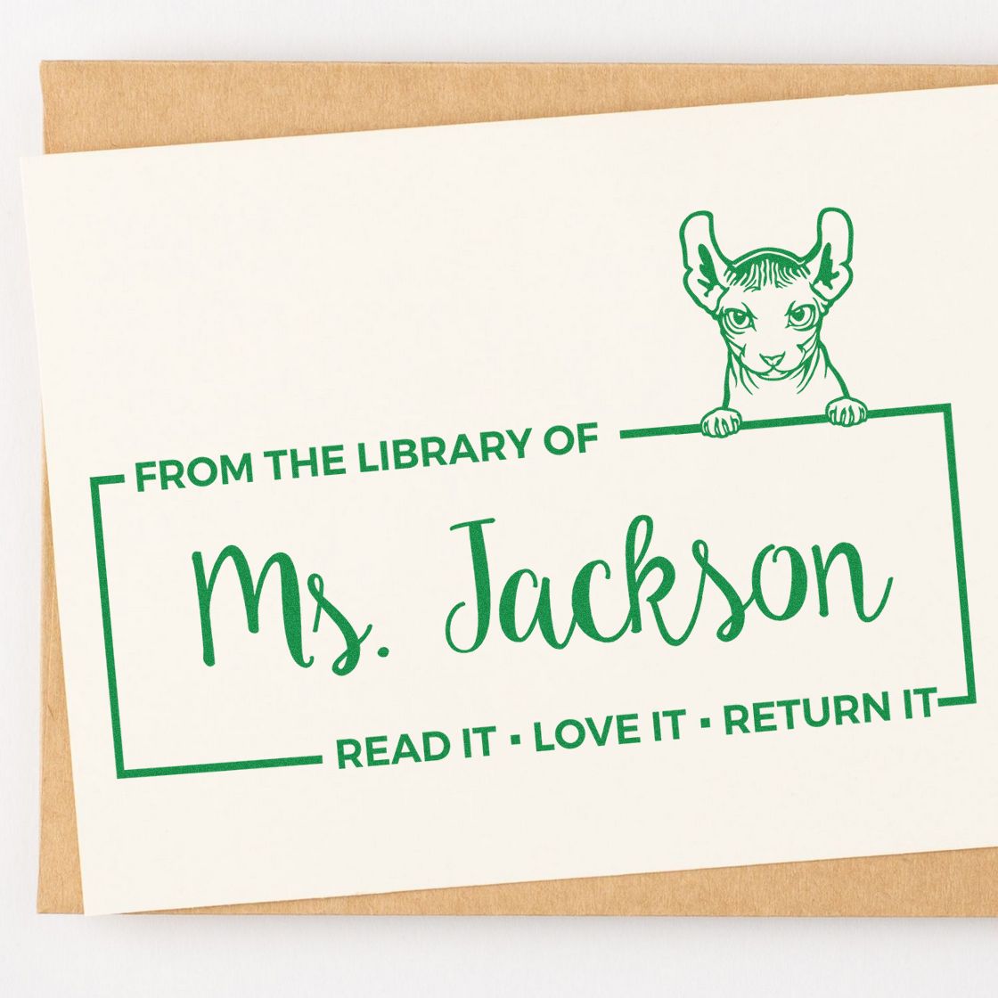 Personalized book stamp reading From the Library of Ms. Jackson with cat design for marking library books.