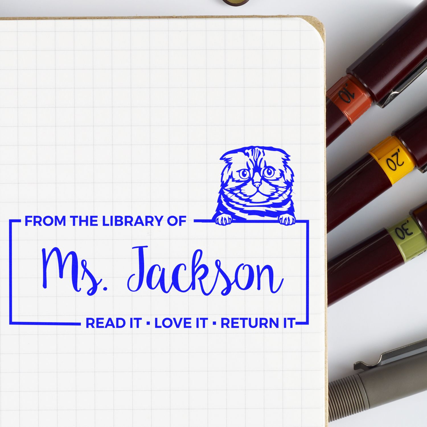 Personalized library rubber stamp for Ms. Jackson with cat design and Read It  Love It  Return It book return message.