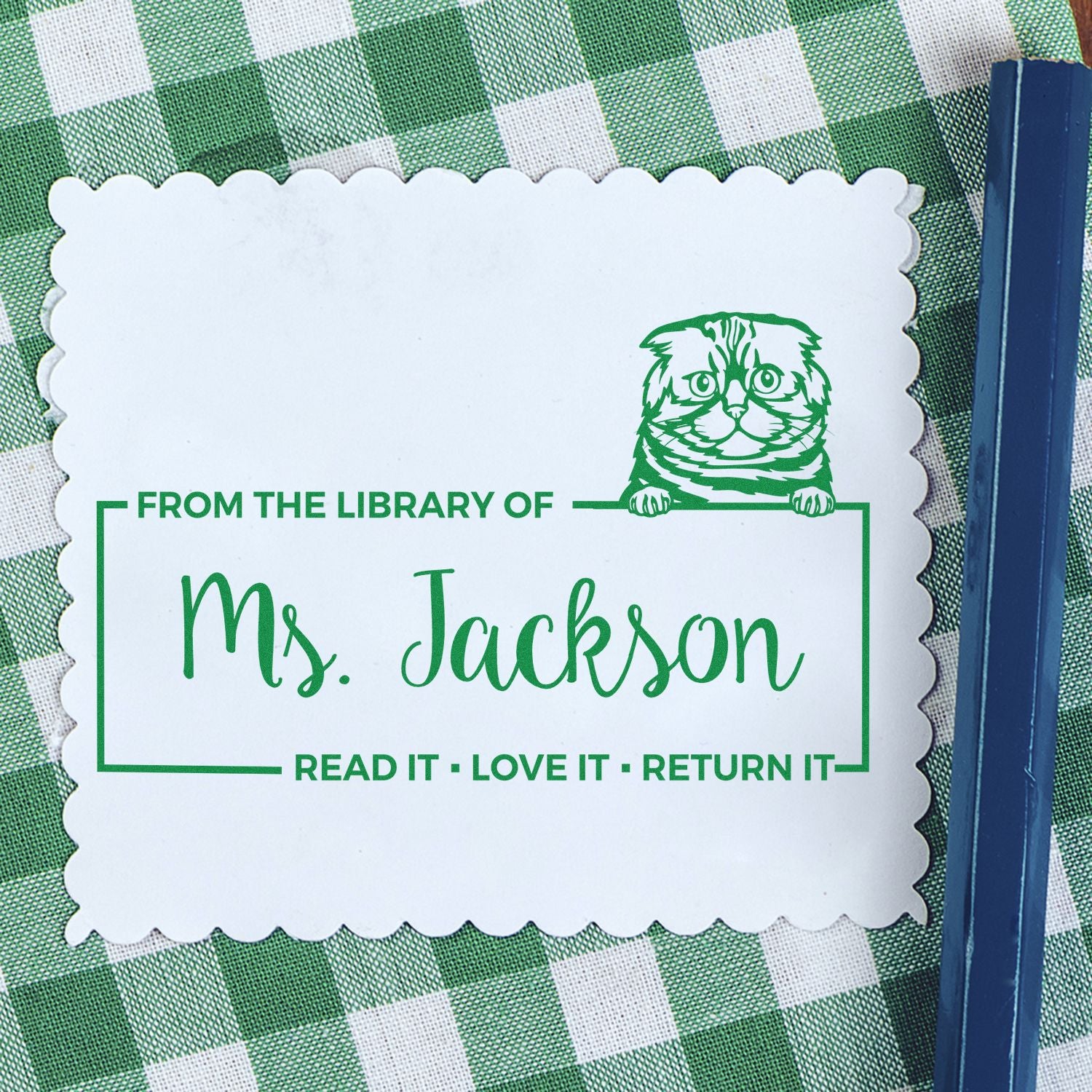 Custom library rubber stamp for Ms. Jackson with cat design and Read it, love it, return it book ownership message.