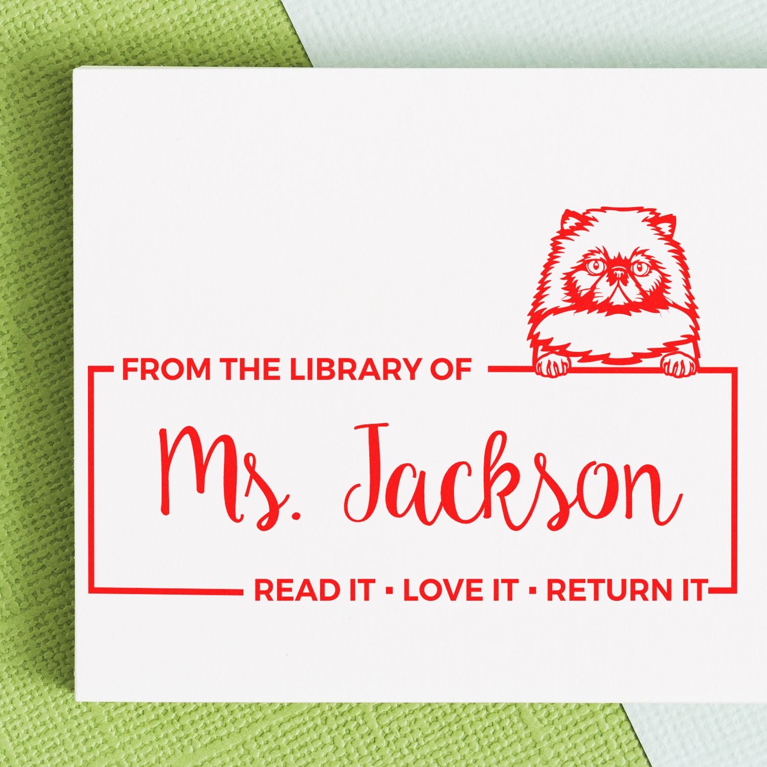 Personalized library rubber stamp with cat design, featuring From the Library of Ms. Jackson and read it, love it, return it text.