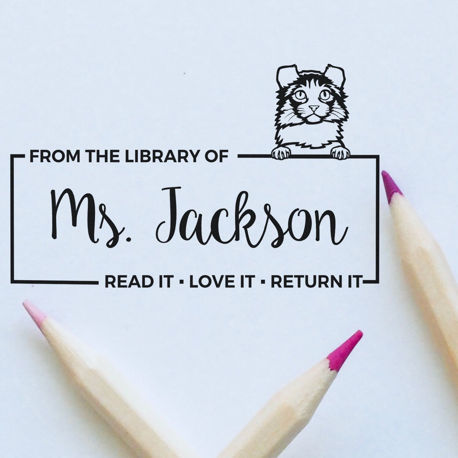 Personalized library rubber stamp for Ms. Jackson, featuring cat art and Read It, Love It, Return It bookplate design.