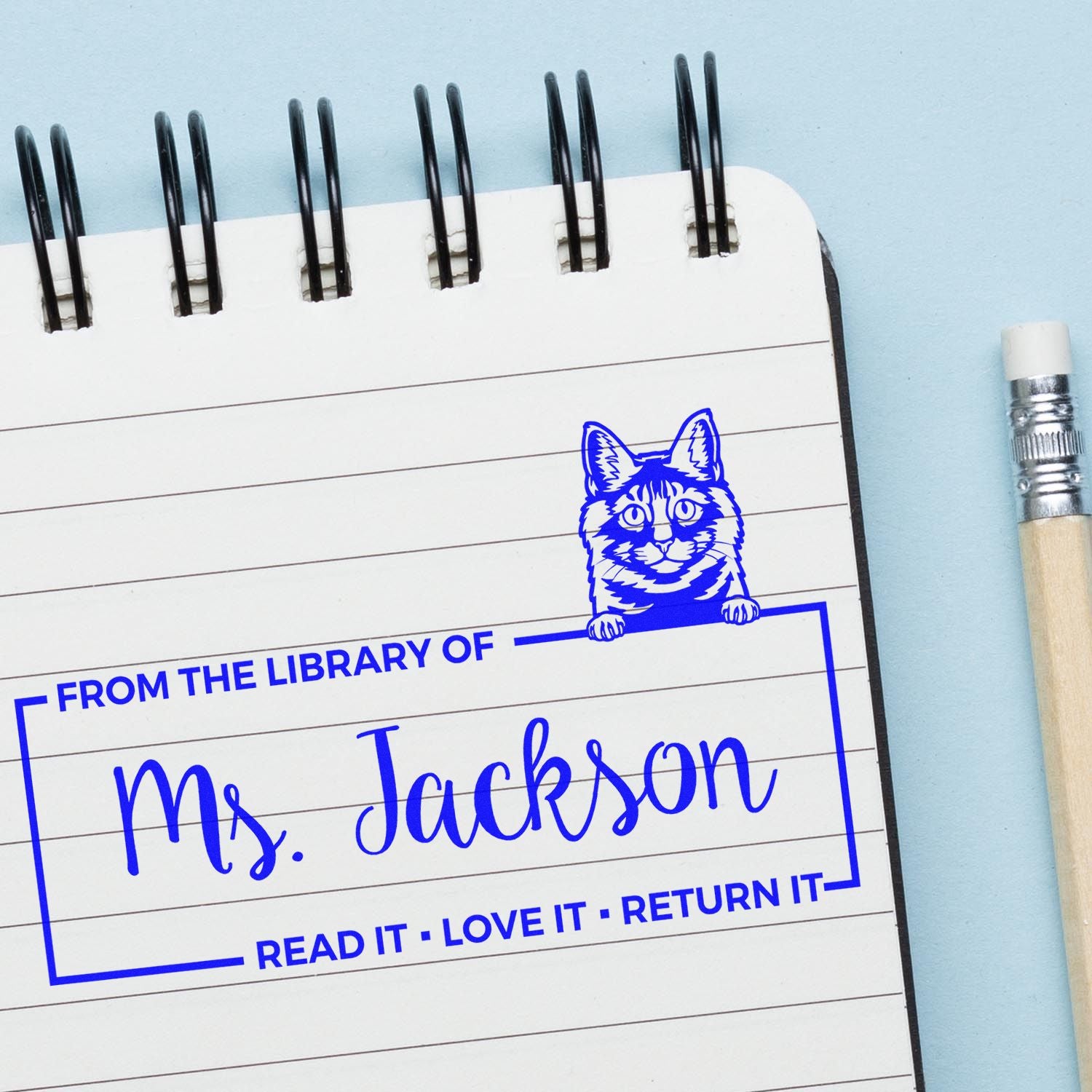 Personalized library rubber stamp for Ms. Jackson with cat design, ideal for marking books and classroom materials.