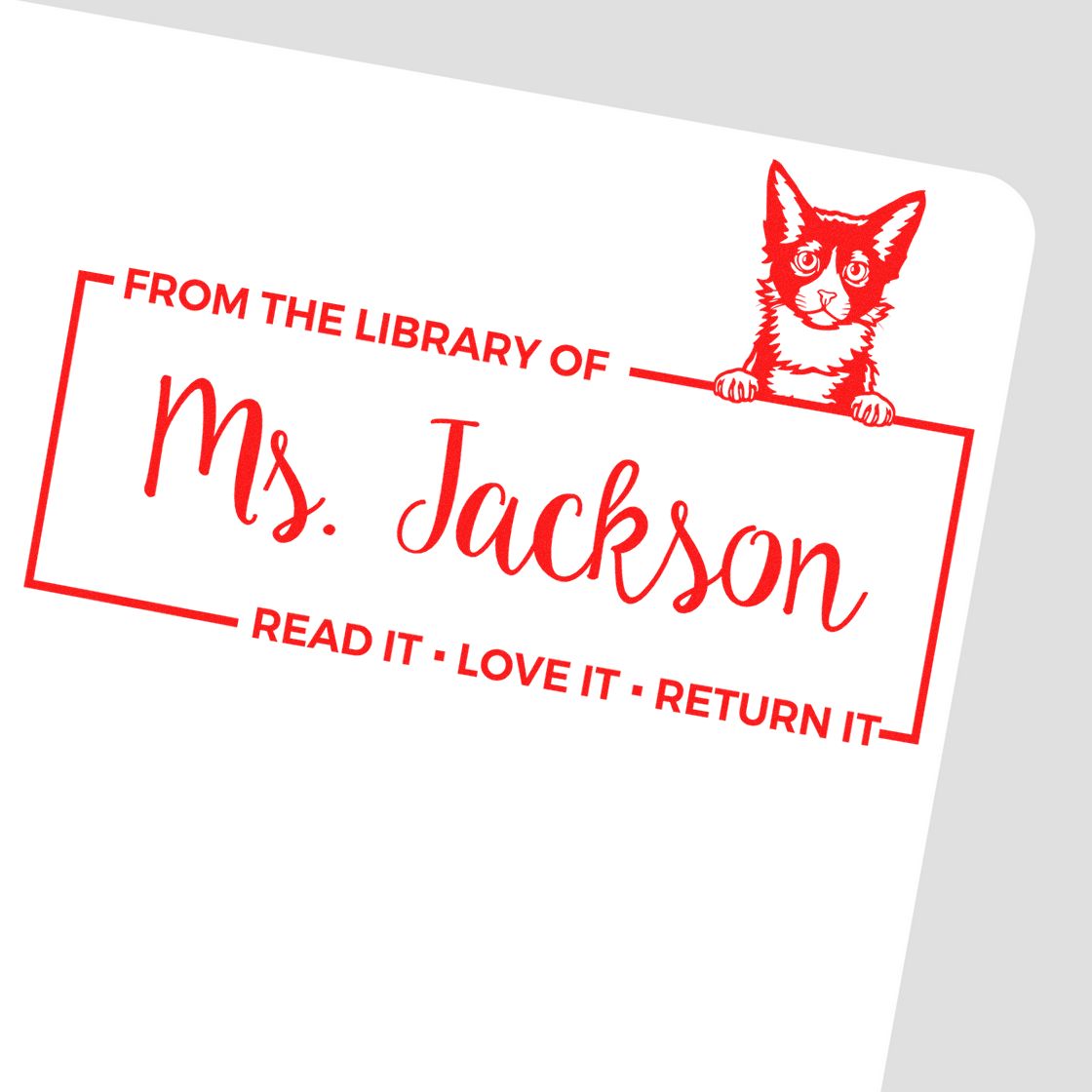 Personalized rubber library stamp for Ms. Jackson with cat graphic and Read it, Love it, Return it book return message.