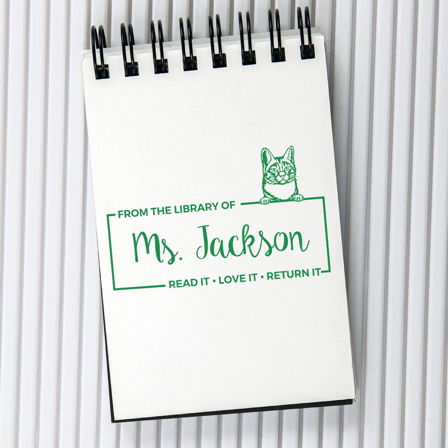 Custom library book rubber stamp for Ms. Jackson with cat design and Read it, Love it, Return it message.
