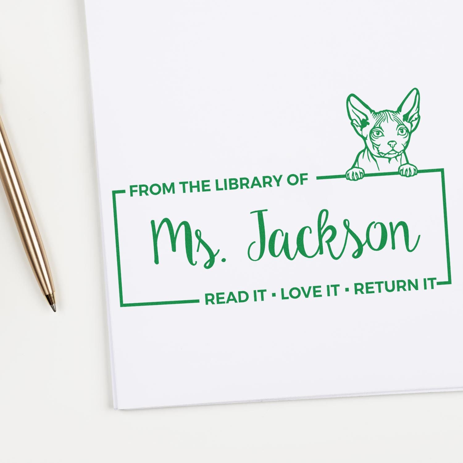 Personalized library rubber stamp with cat design for Ms. Jackson, featuring Read It, Love It, Return It book ownership label.