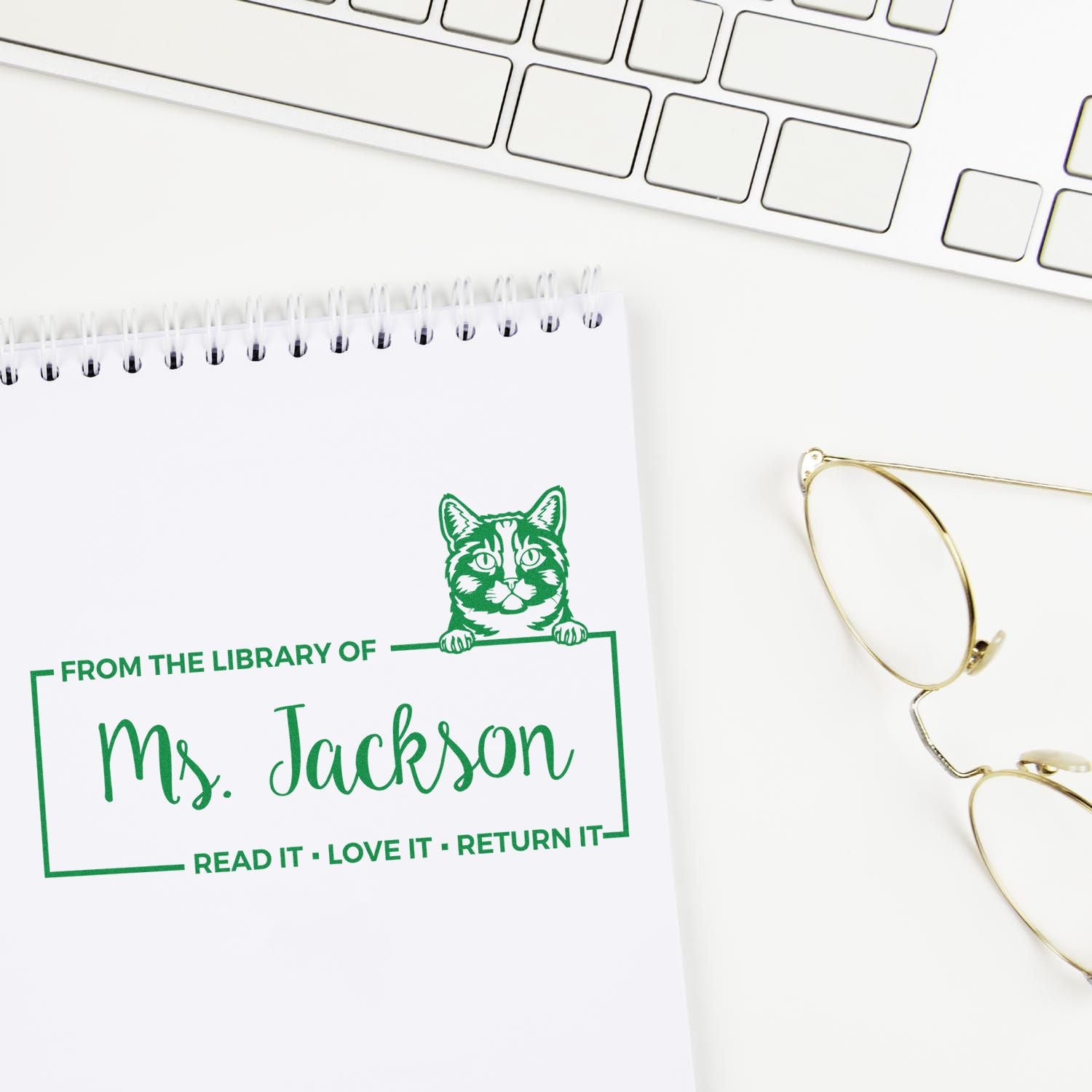 Custom rubber library stamp for Ms. Jackson with cat design and Read it, love it, return it book ownership message.