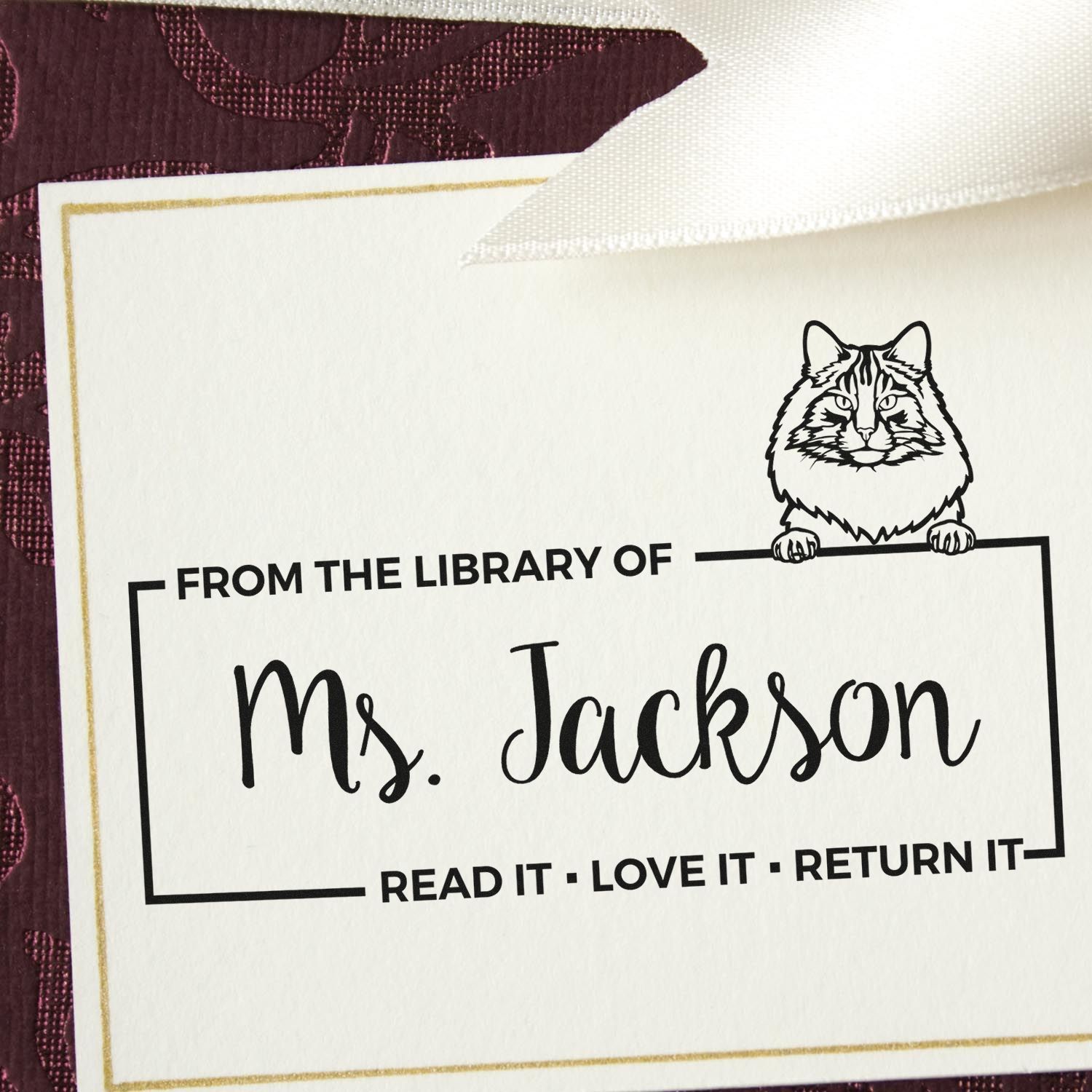 Custom library rubber stamp with cat bookplate reading From the Library of Ms. Jackson and Read It  Love It  Return It.
