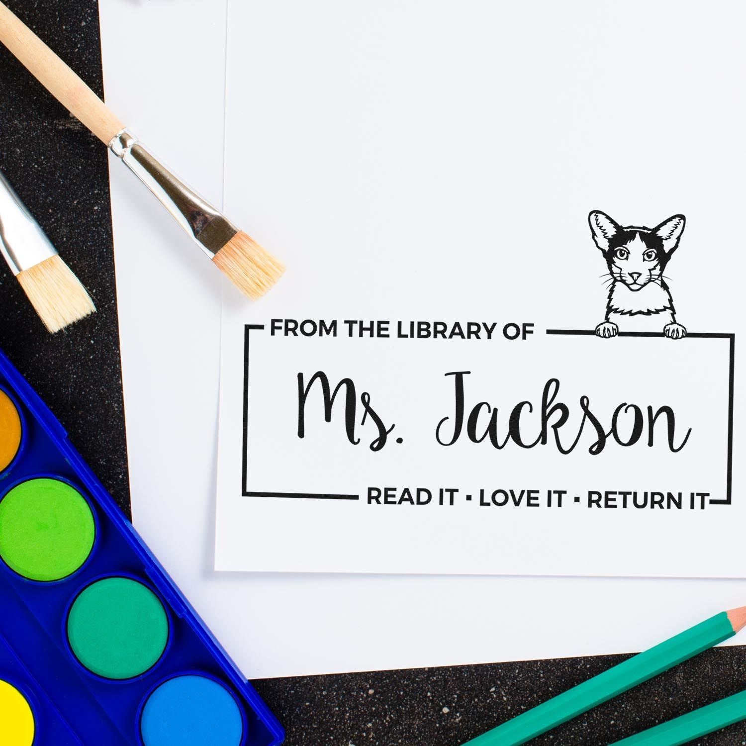 Custom rubber library stamp for Ms. Jackson bookplate, featuring a cat and the phrase Read it, Love it, Return it.