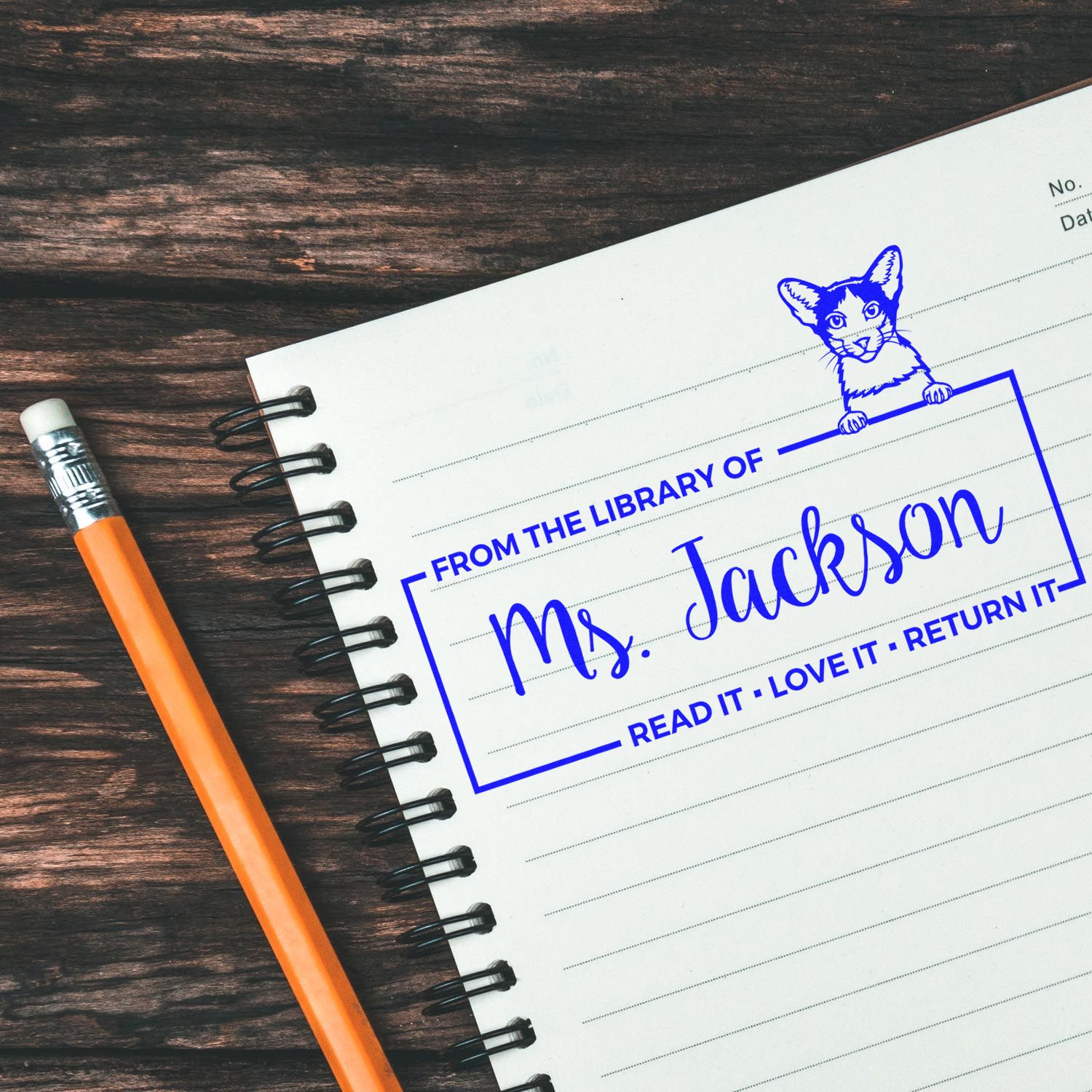 Custom library rubber stamp with cat design and From the Library of Ms. Jackson return-it book ownership imprint.