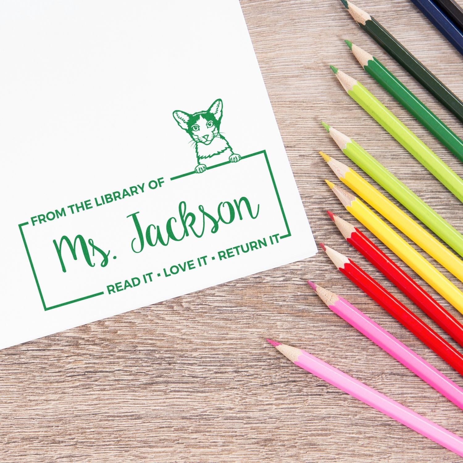 Custom library rubber stamp with cat design, From the Library of Mrs. Jackson bookplate on paper with colored pencils