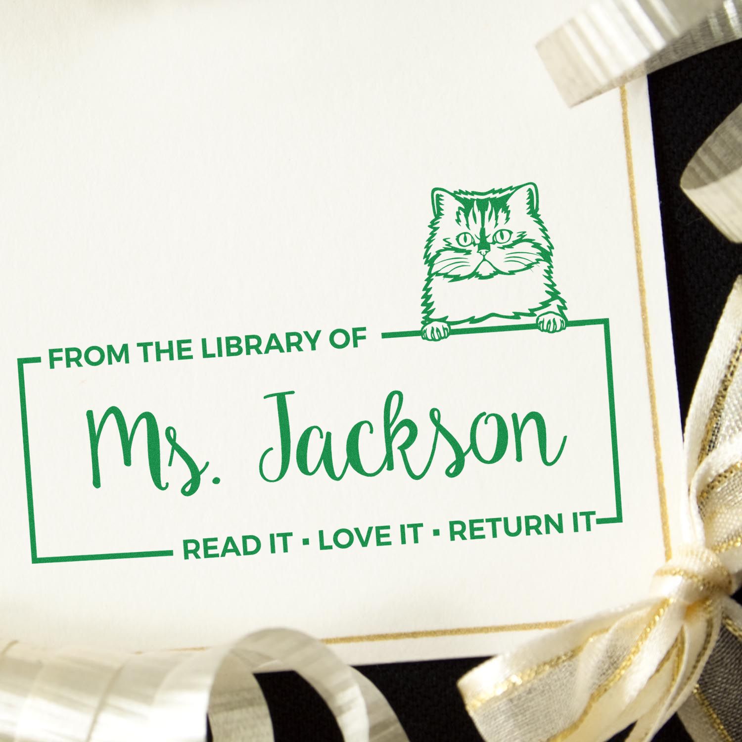 Personalized cat library rubber stamp for Ms. Jackson with Read it, love it, return it book ownership message.