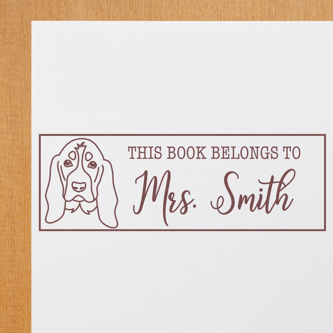 Personalized rubber stamp with dog portrait and This Book Belongs to Mrs. Smith for custom library book labels.